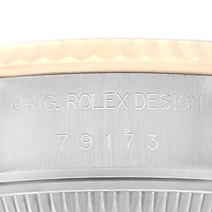 The image shows a close-up of the case side of a Rolex Datejust 79173 Women's Steel and Gold (two tone) Silver Dial 79173 Women's Steel and Gold (two tone) Silver Dial, highlighting the engraved serial number "79173" and "ORIG. ROLEX DESIGN".