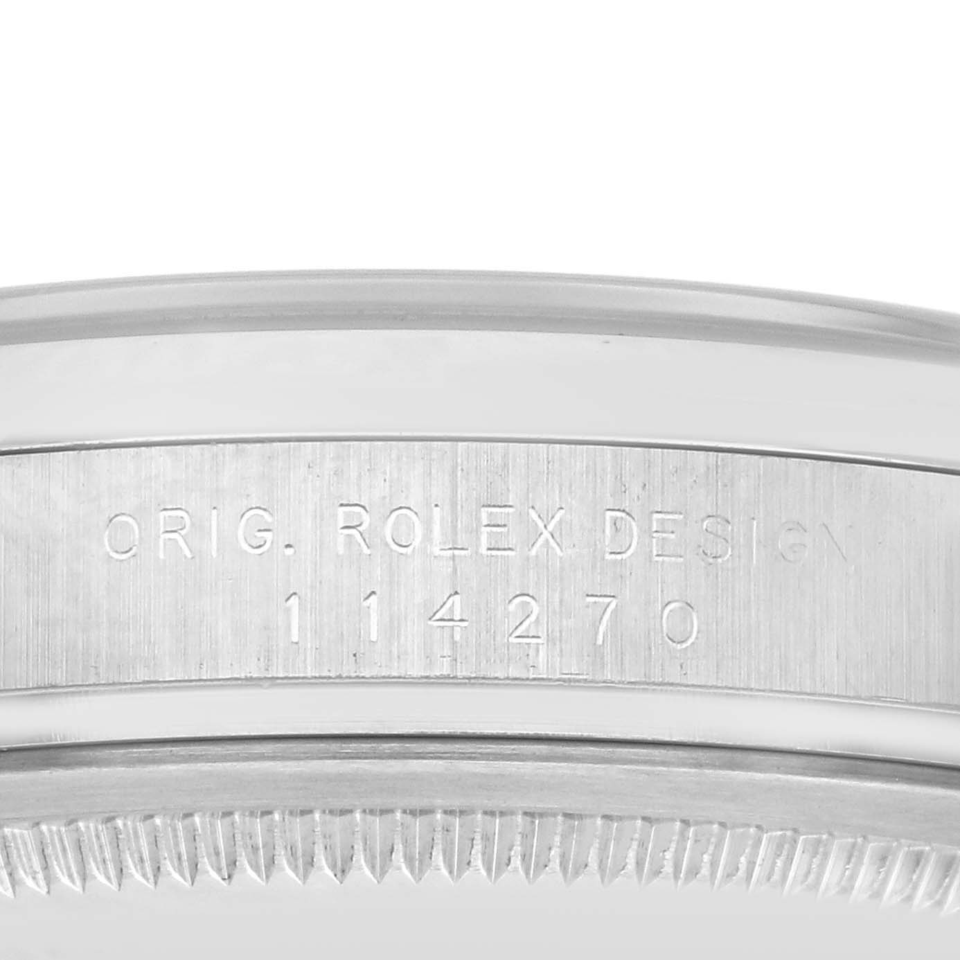 The image shows a close-up of the case side of a Rolex Explorer 114270 Men
s Stainless Steel Black Dial 114270 Men
s Stainless Steel Black Dial, displaying the model number and "Orig. Rolex Design" engraving.