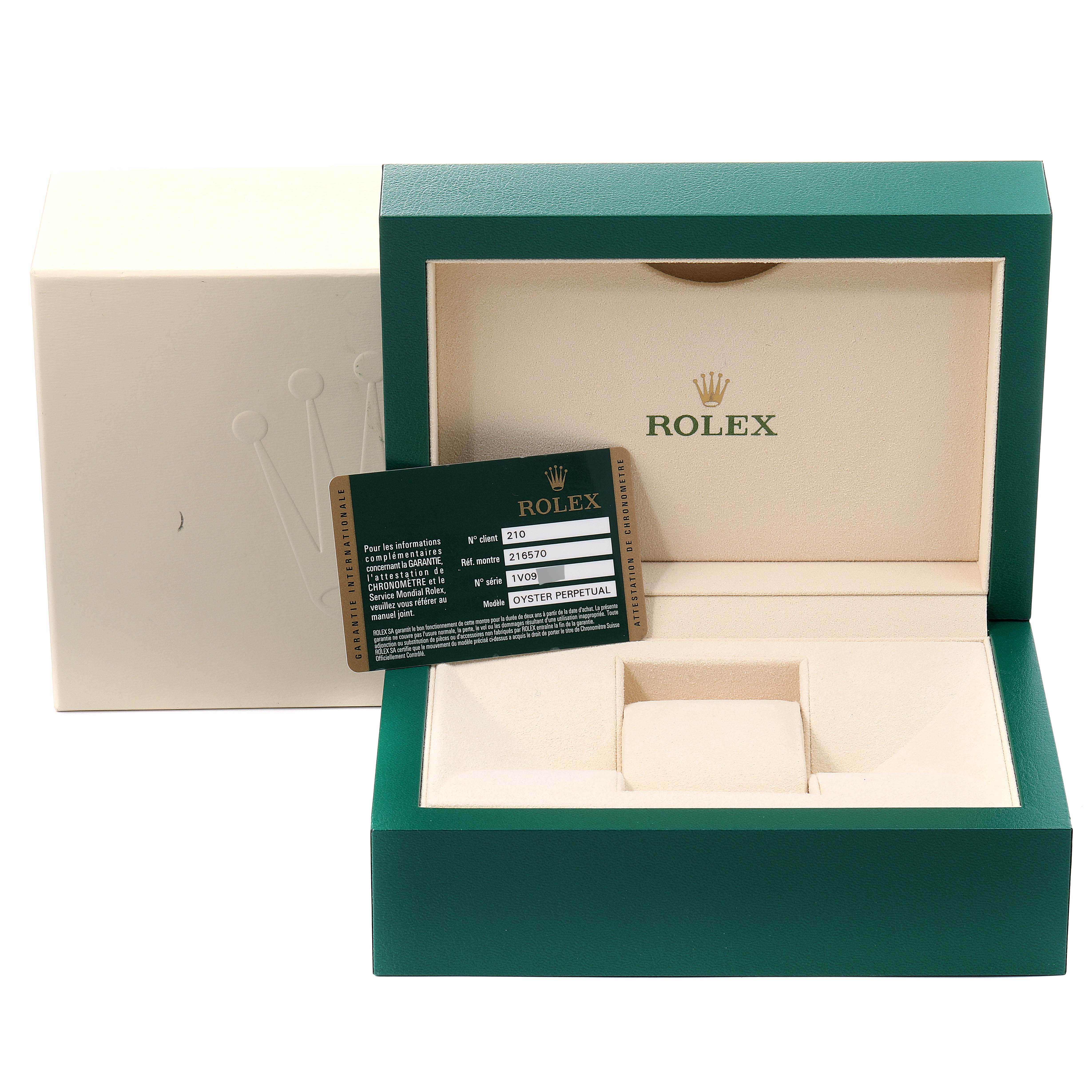 The image shows the packaging, warranty card, and watch cushion for the Rolex Explorer 216570 Men
s Stainless Steel Black Dial 216570 Men
s Stainless Steel Black Dial model.