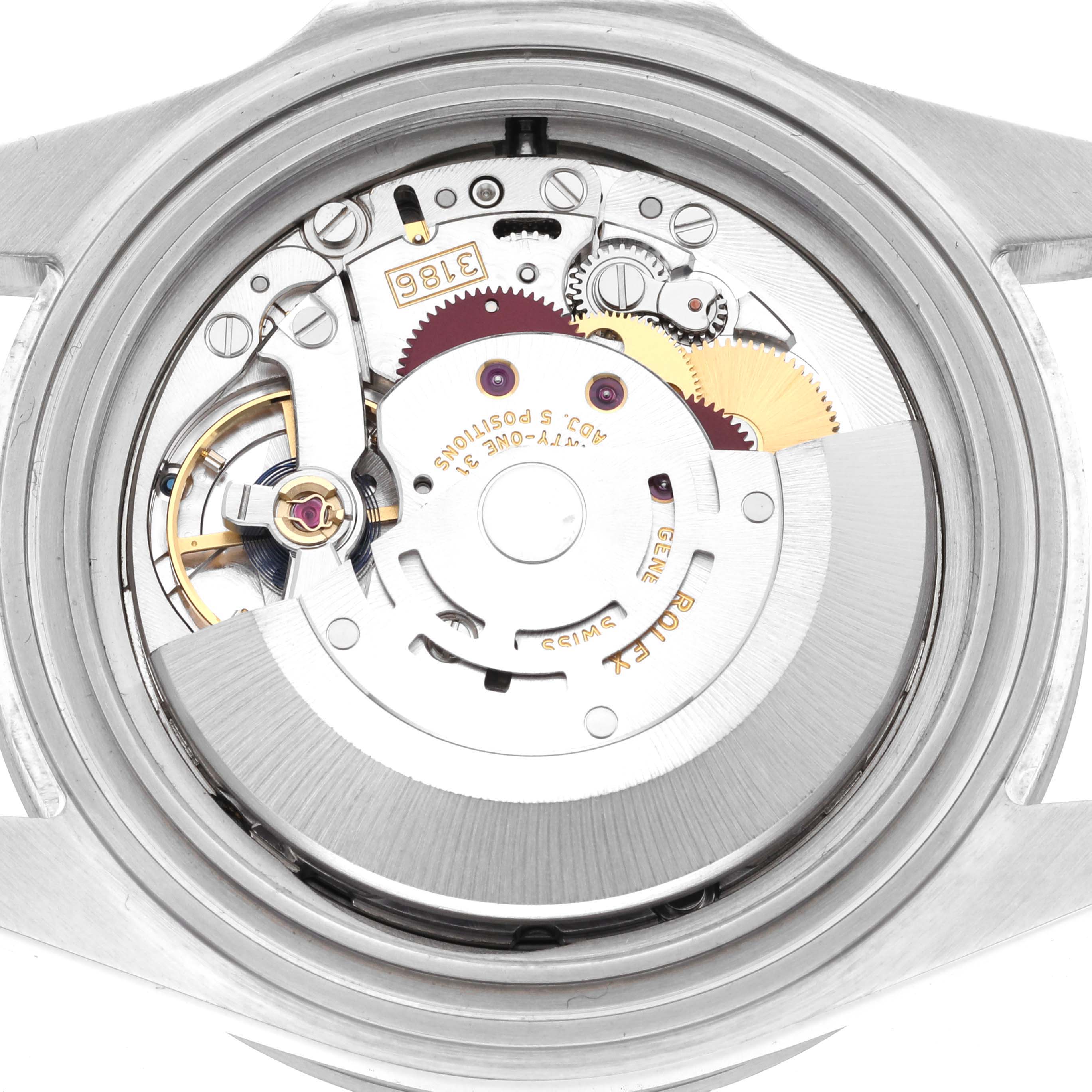 The image shows the movement of a Rolex Explorer 16570T Men
s Stainless Steel Black Dial 16570T Men
s Stainless Steel Black Dial watch from a top-down angle, highlighting intricate gears and components.