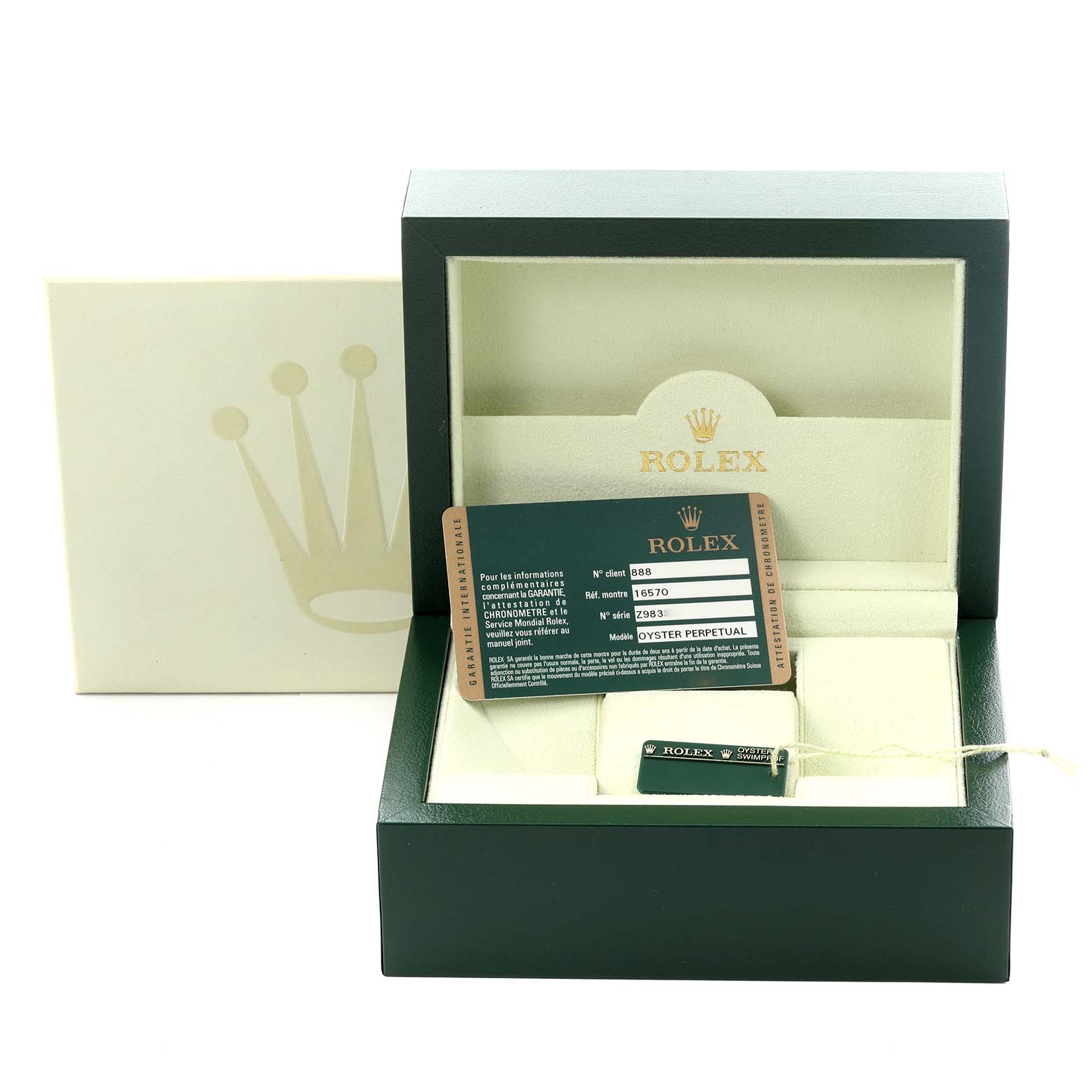 The image shows the packaging and accessories (tag and card) for a Rolex Explorer 16570T Men
s Stainless Steel Black Dial 16570T Men
s Stainless Steel Black Dial watch.