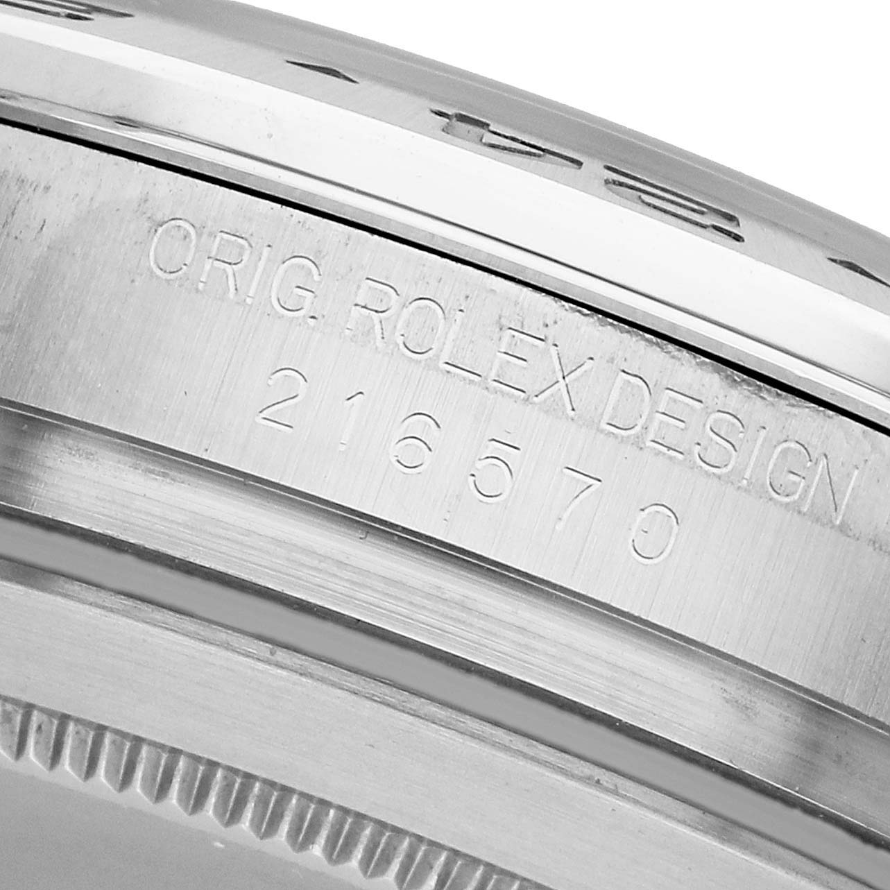 The image shows a close-up of the edge and side of the Rolex Explorer 216570 Men's Stainless Steel White Dial watch, highlighting the model number "216570" engraved.