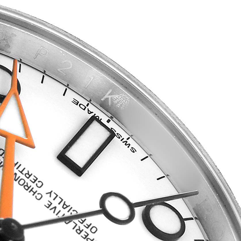 The image shows a close-up of the dial and bezel of a Rolex Explorer 216570 Men's Stainless Steel White Dial watch, highlighting the markers and hands.