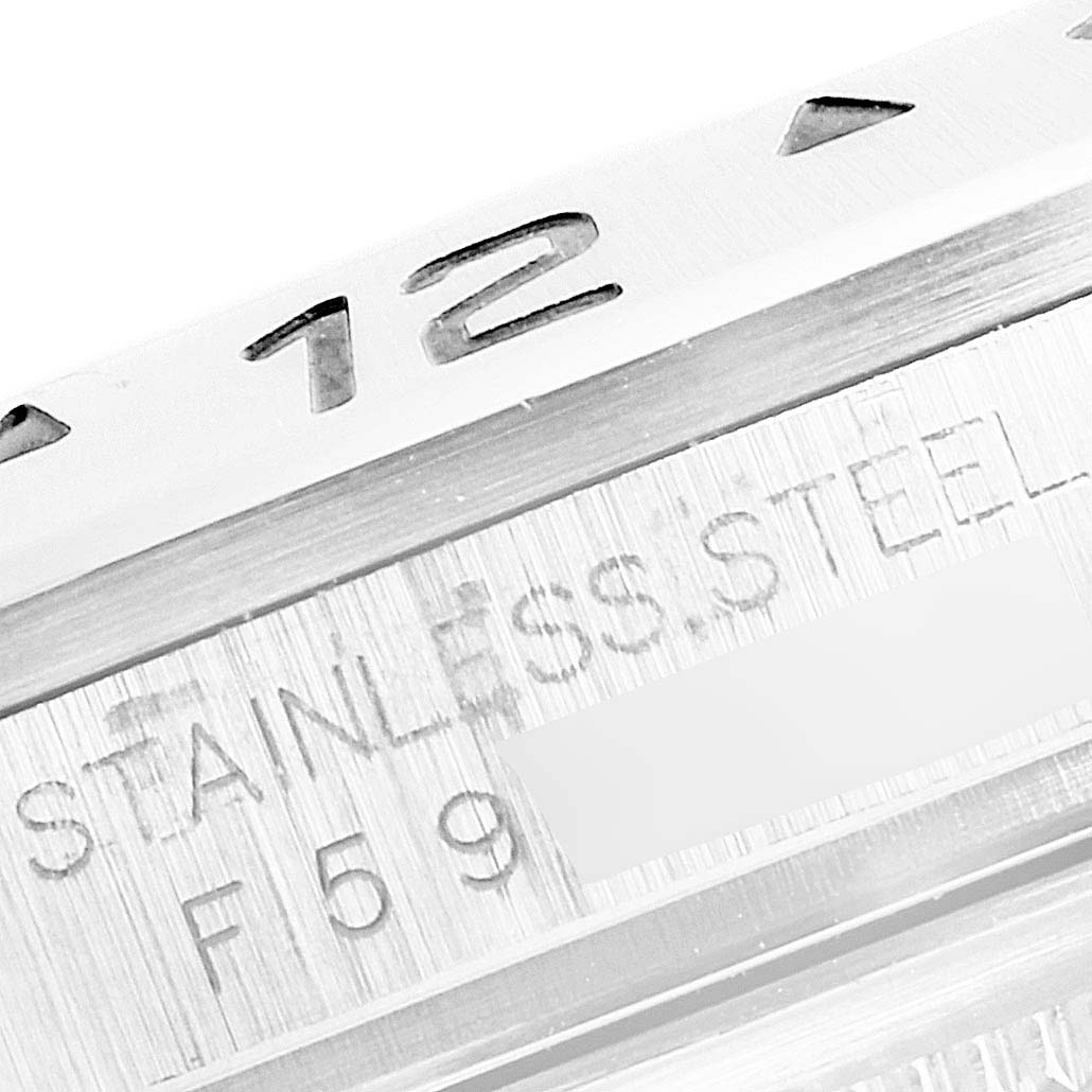 This close-up image shows the engraved bezel and case of the Rolex Explorer 16570 Men
s Stainless Steel White Dial 16570 Men
s Stainless Steel White Dial watch, highlighting the "12" and "STAINLESS STEEL."