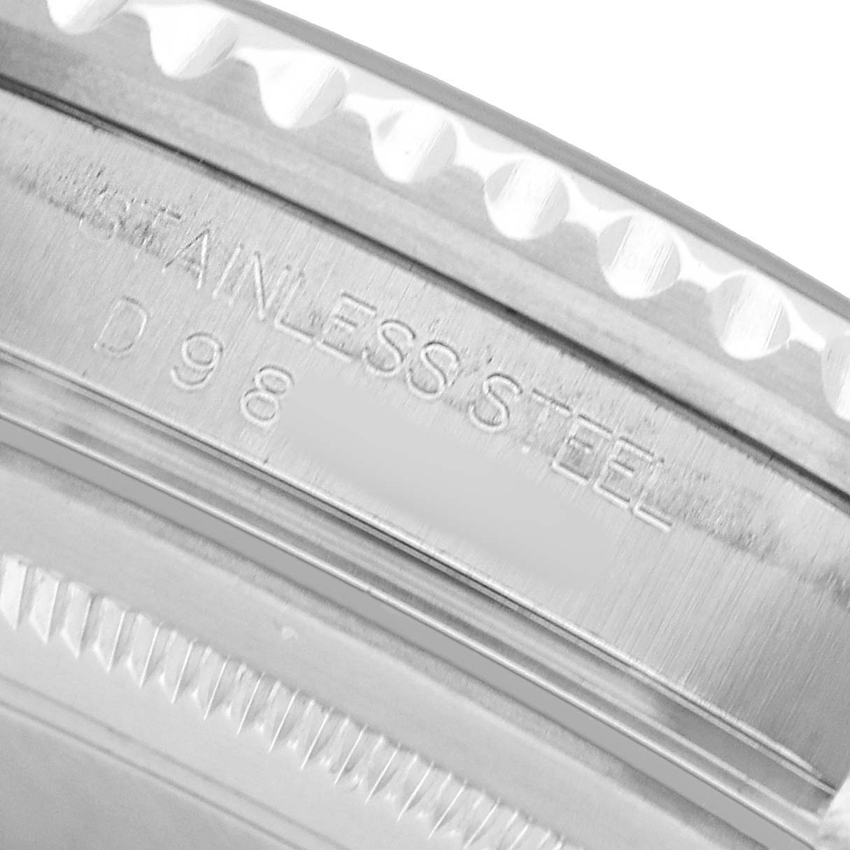 The image shows a close-up of the stainless steel case side of a Rolex GMT-Master 16710 Men's Stainless Steel Black Dial, highlighting the engraved details.