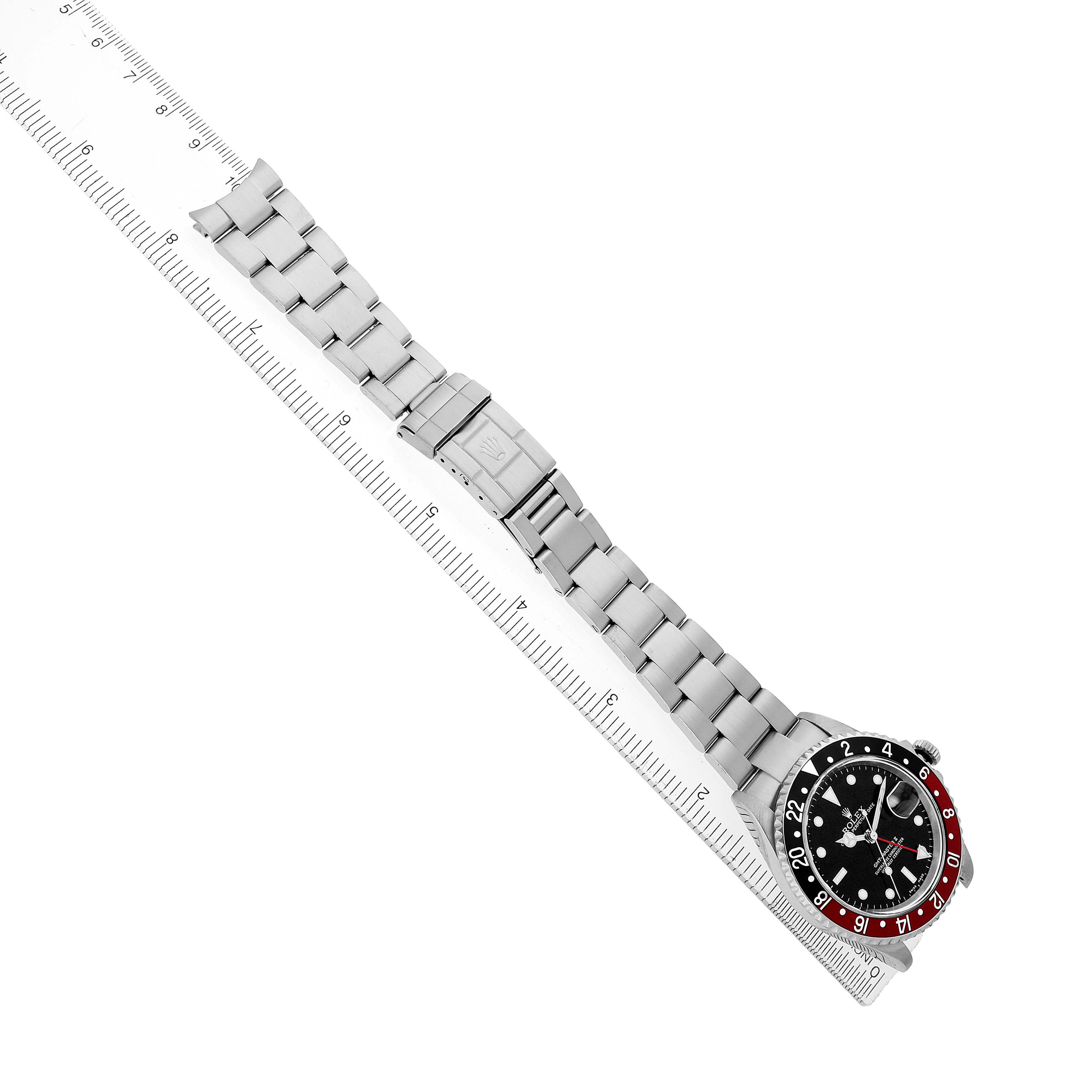 The Rolex GMT-Master 16710 Men's Stainless Steel Black Dial watch is shown from a top-down angle, displaying its entire bracelet, clasp, and bezel.