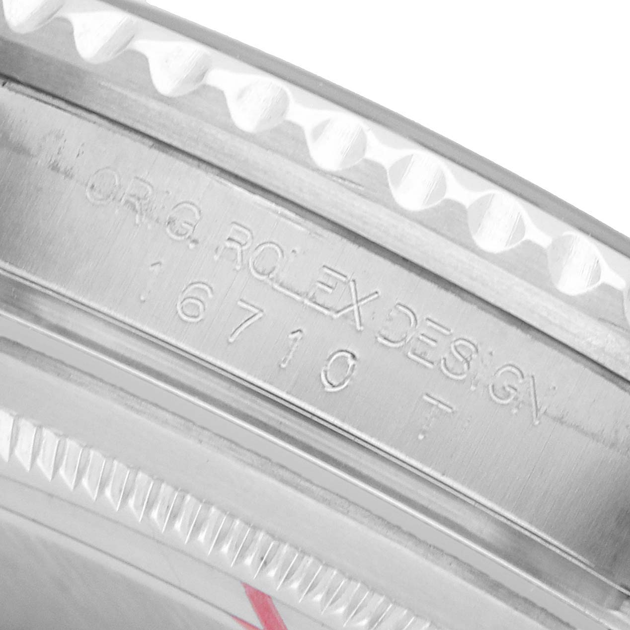 The image shows a close-up of the engraved inner bezel of a Rolex GMT-Master 16710 Men's Stainless Steel Black Dial watch model 16710.