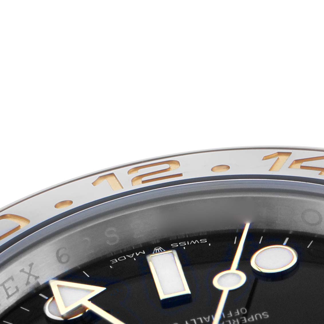 The image shows a close-up of the Rolex GMT-Master 126713 Men's Steel and Gold (two tone) Black Dial's bezel and part of the dial, viewed at a slanted angle.