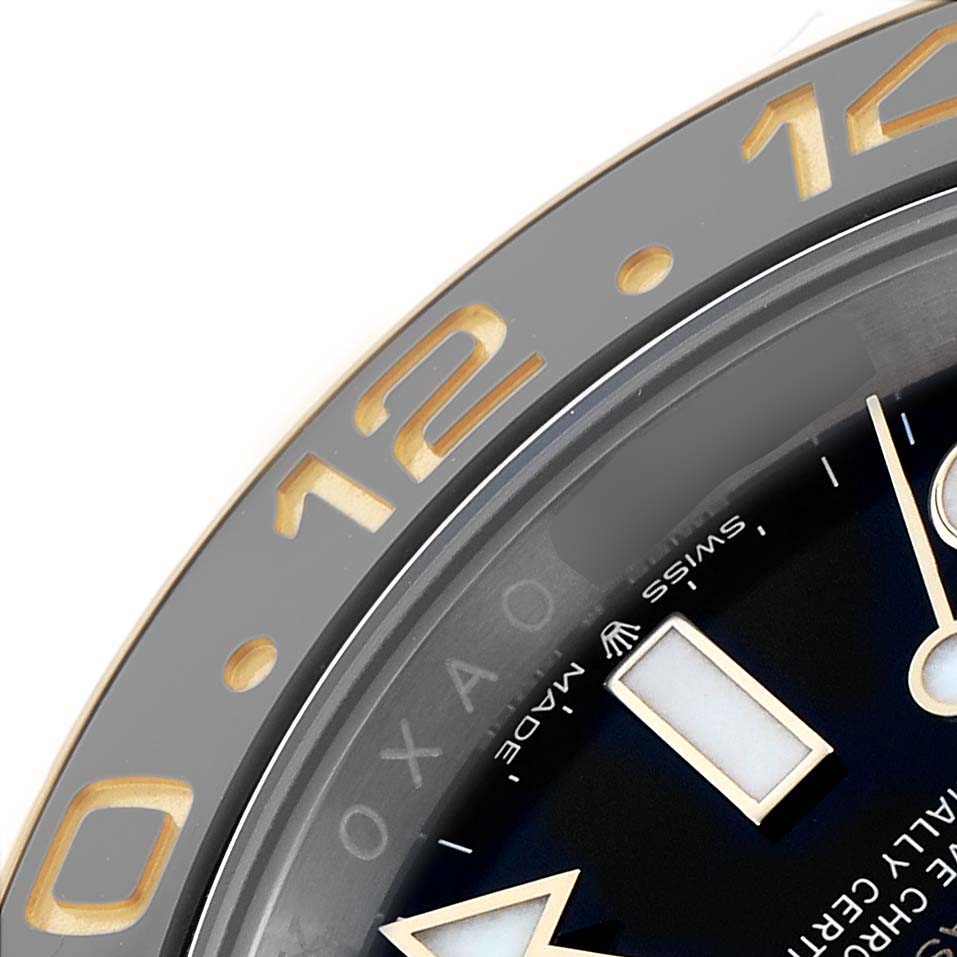 The image shows a close-up of the Rolex GMT-Master 126713 Men's Steel and Gold (two tone) Black Dial watch, focusing on the bezel and part of the dial.