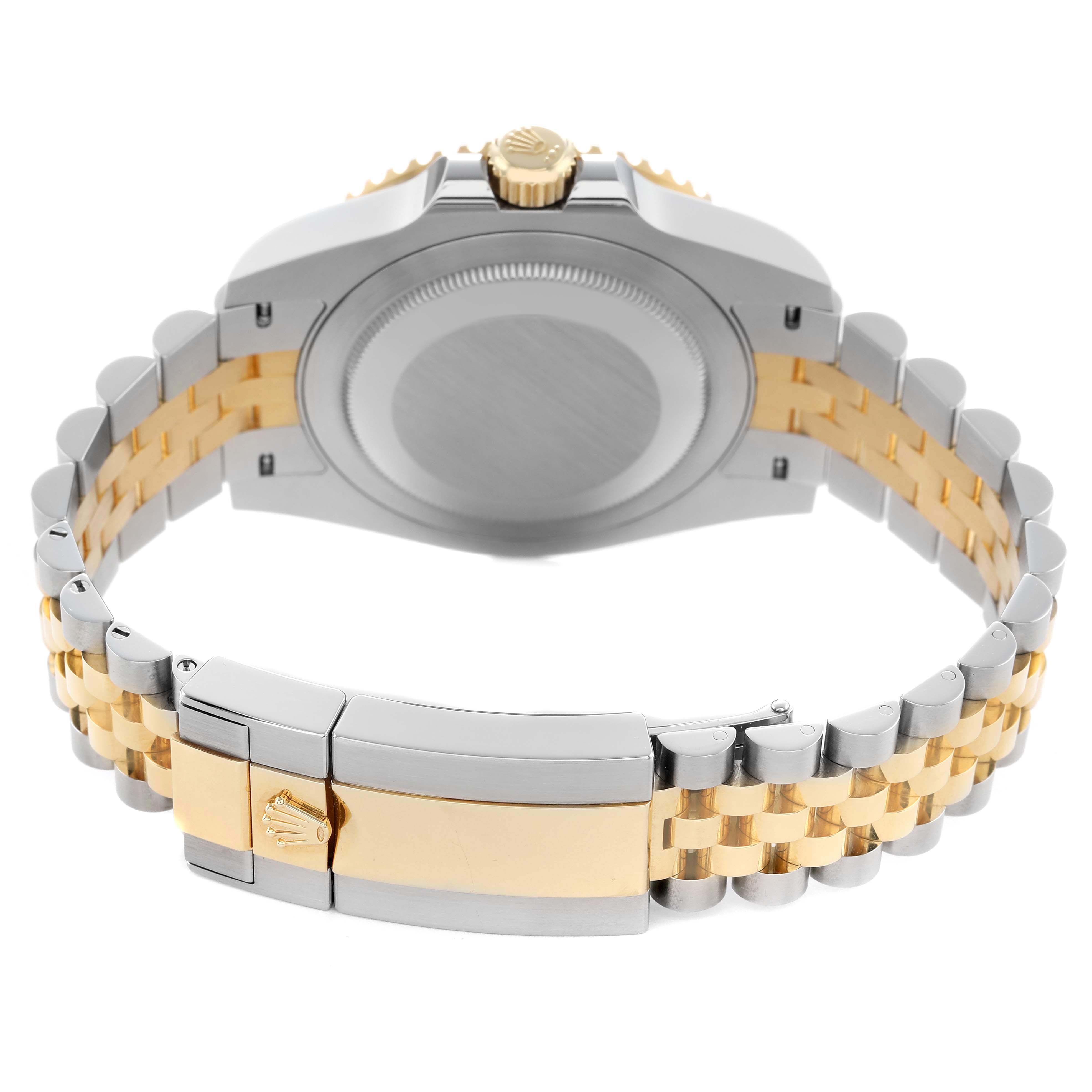 The image shows the back and bracelet of the Rolex GMT-Master 126713 Men's Steel and Gold (two tone) Black Dial, highlighting the two-tone metal and the clasp with a logo.