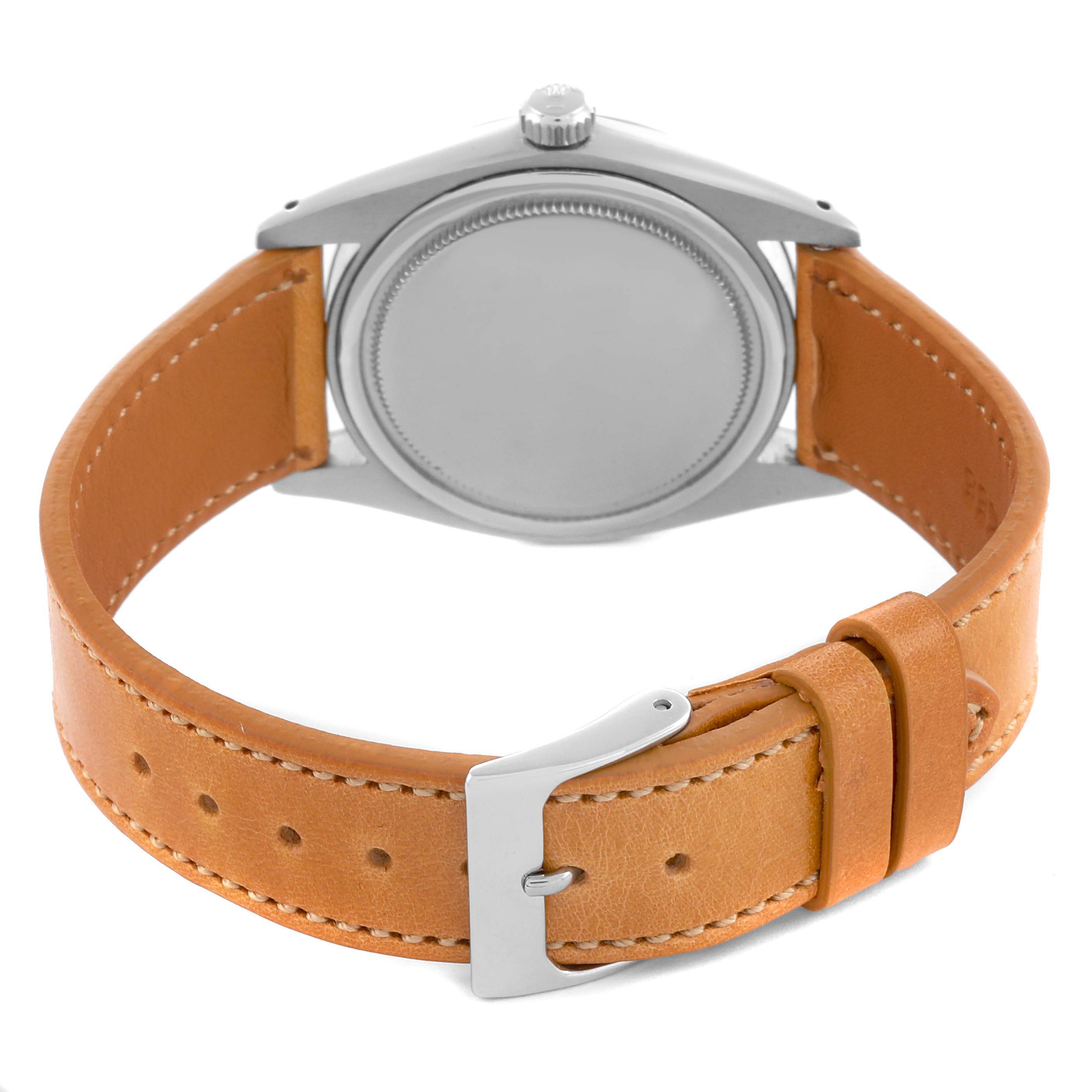 The Rolex Vintage Collection 6694 Men's Stainless Steel Silver Dial 6694 Men's Stainless Steel Silver Dial watch is shown from the back, highlighting its case, crown, and tan leather strap.