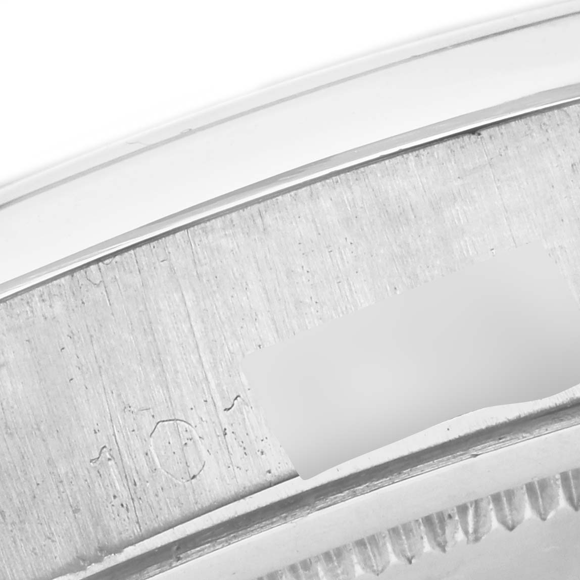 The image shows a close-up of the inner side of the Rolex Vintage Collection 6694 Men's Stainless Steel Silver Dial 6694 Men's Stainless Steel Silver Dial watch bezel, highlighting engraved markings.
