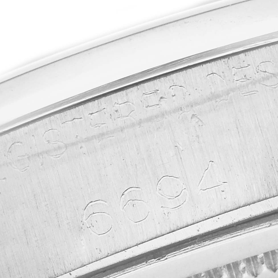 The angle shows a close-up of the engraved model number on the side of the Rolex Vintage Collection 6694 Men's Stainless Steel Silver Dial 6694 Men's Stainless Steel Silver Dial watch case.