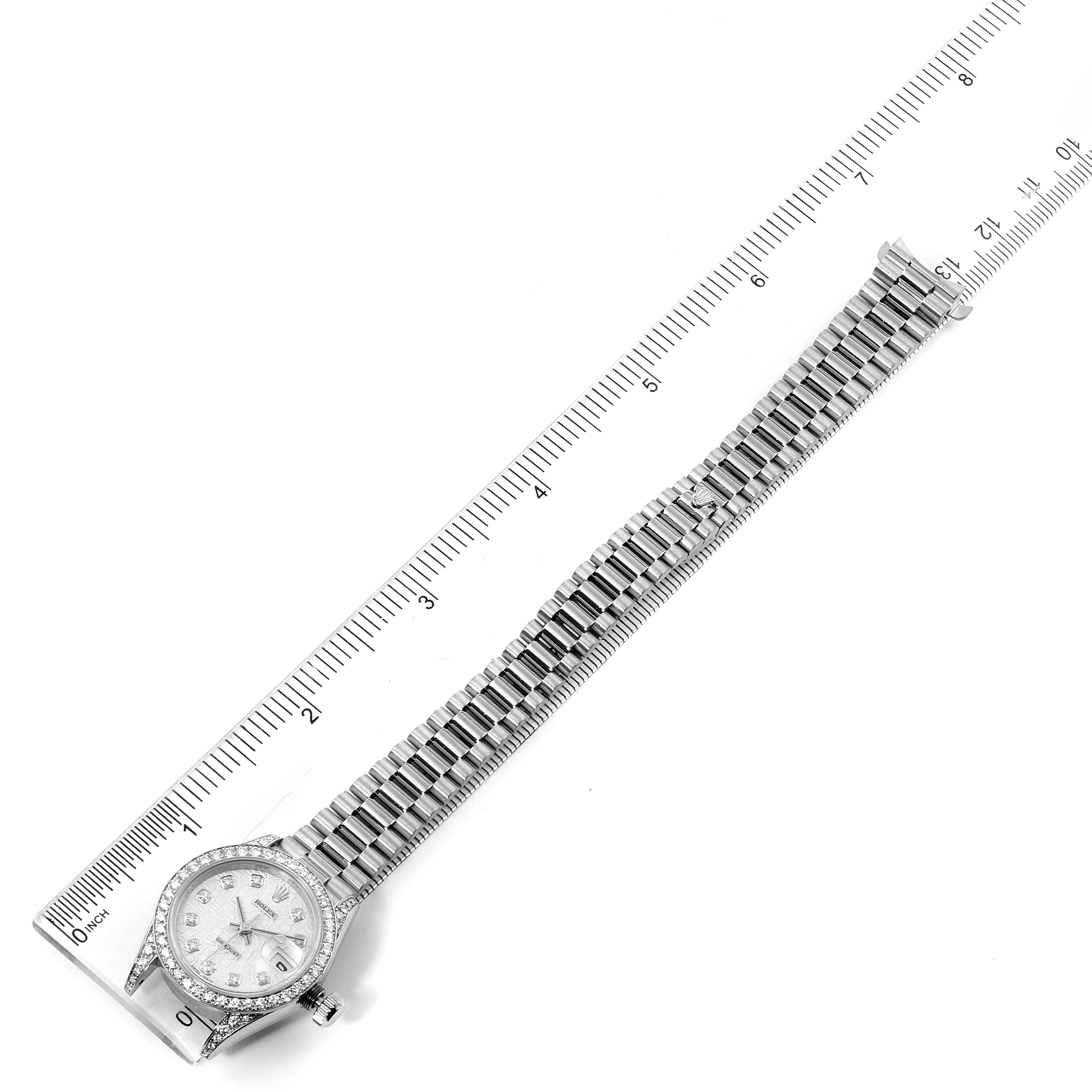 The image shows a top-down view of a Rolex President 69159 Women's White Gold Silver Dial 69159 Women's White Gold Silver Dial model watch, displaying the entire watch and its bracelet alongside a ruler.
