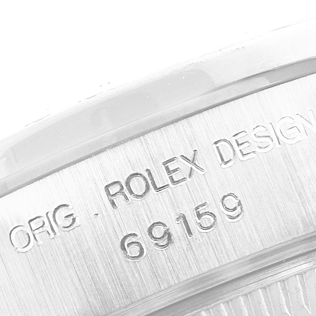 This close-up image shows the engraved case side of a Rolex President 69159 Women's White Gold Silver Dial 69159 Women's White Gold Silver Dial model watch.