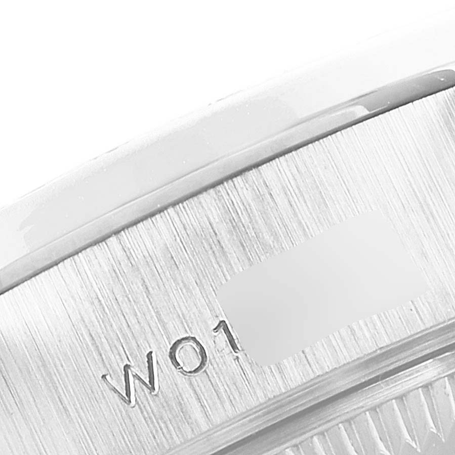 The image shows a close-up of the edge and serial number engraving on a Rolex President 69159 Women's White Gold Silver Dial 69159 Women's White Gold Silver Dial model watch.