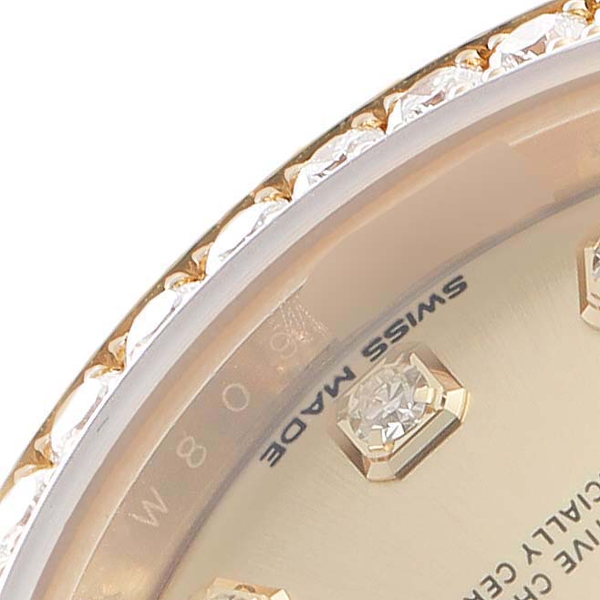 The image shows a close-up of the bezel and part of the dial with diamond markers on a Rolex President 279138 Women's Yellow Gold Champagne Dial watch.