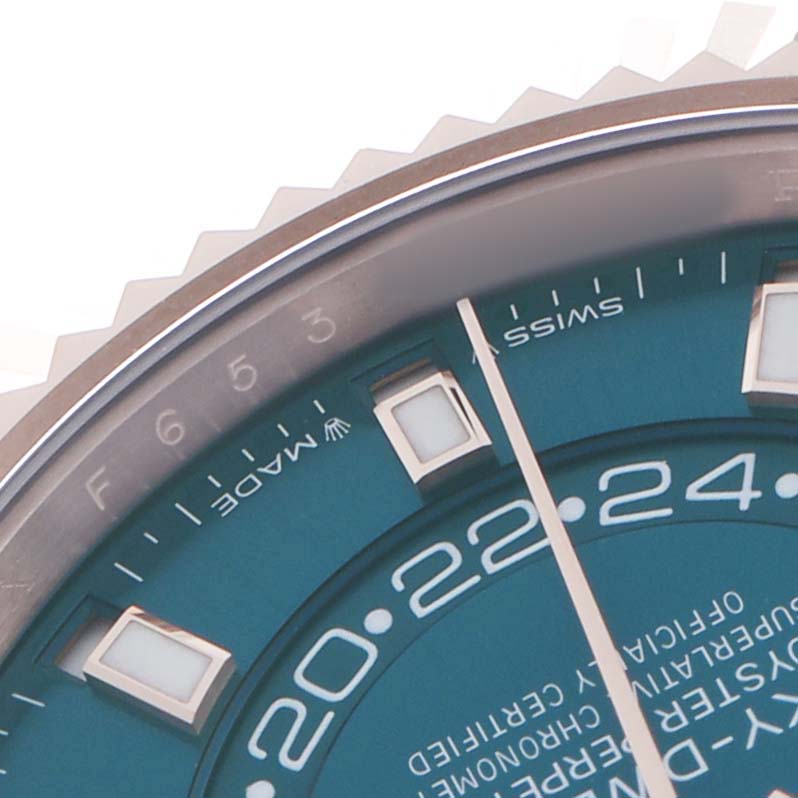 The image shows a close-up of the Rolex Sky-Dweller 336935 Men's Rose Gold Blue Dial's dial and part of the bezel, focusing on the markers and text.