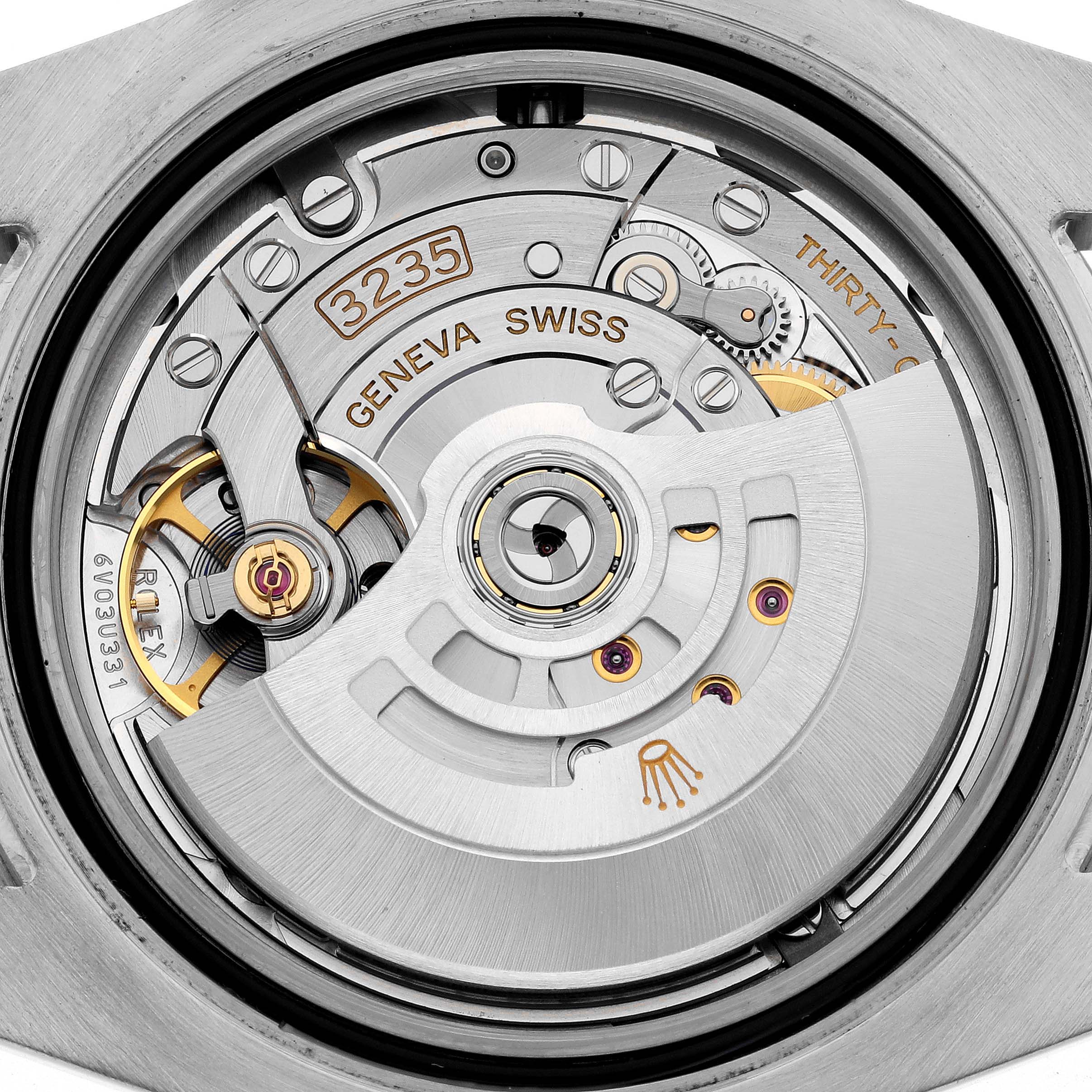 The image shows the internal movement of a Rolex Submariner 126613LB Men's Steel and Gold (two tone) Blue Dial 126613LB Men's Steel and Gold (two tone) Blue Dial, highlighting the intricate mechanism and rotor.