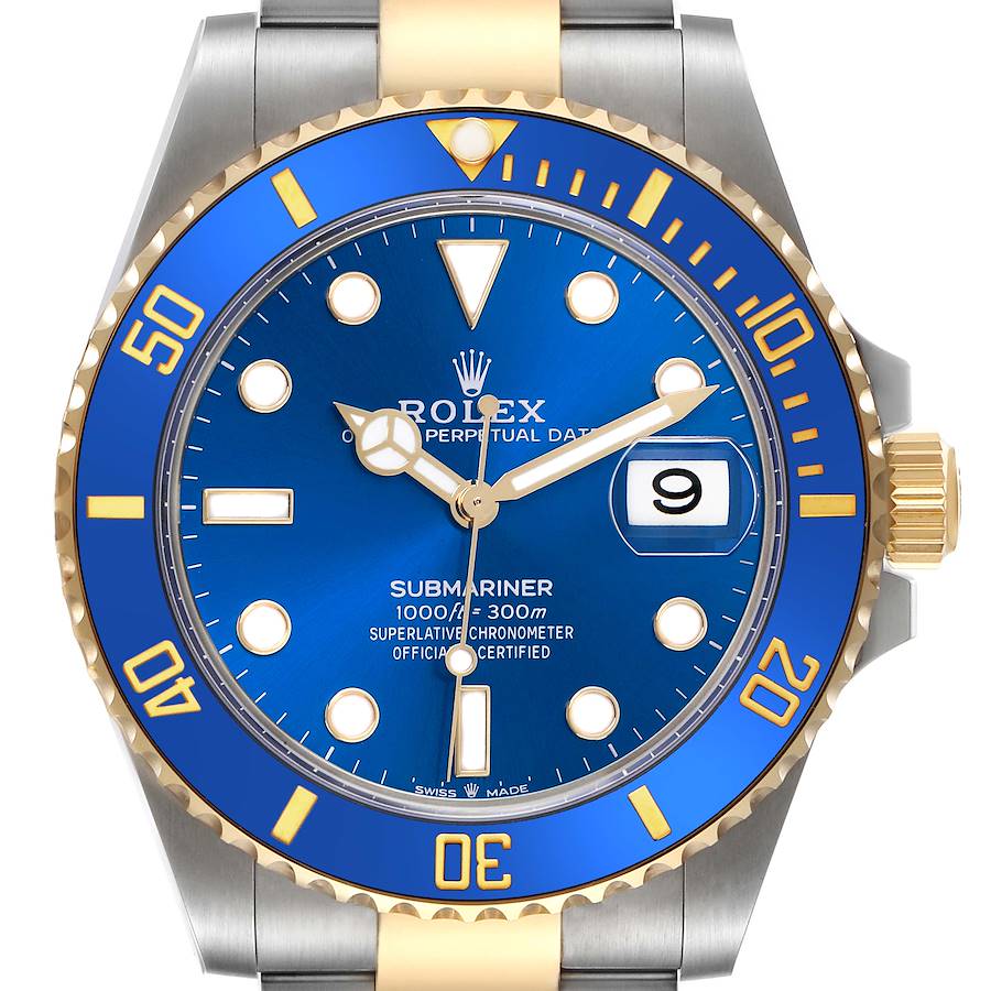 The image shows a front view of the Rolex Submariner, highlighting its blue dial, bezel, and gold crown.