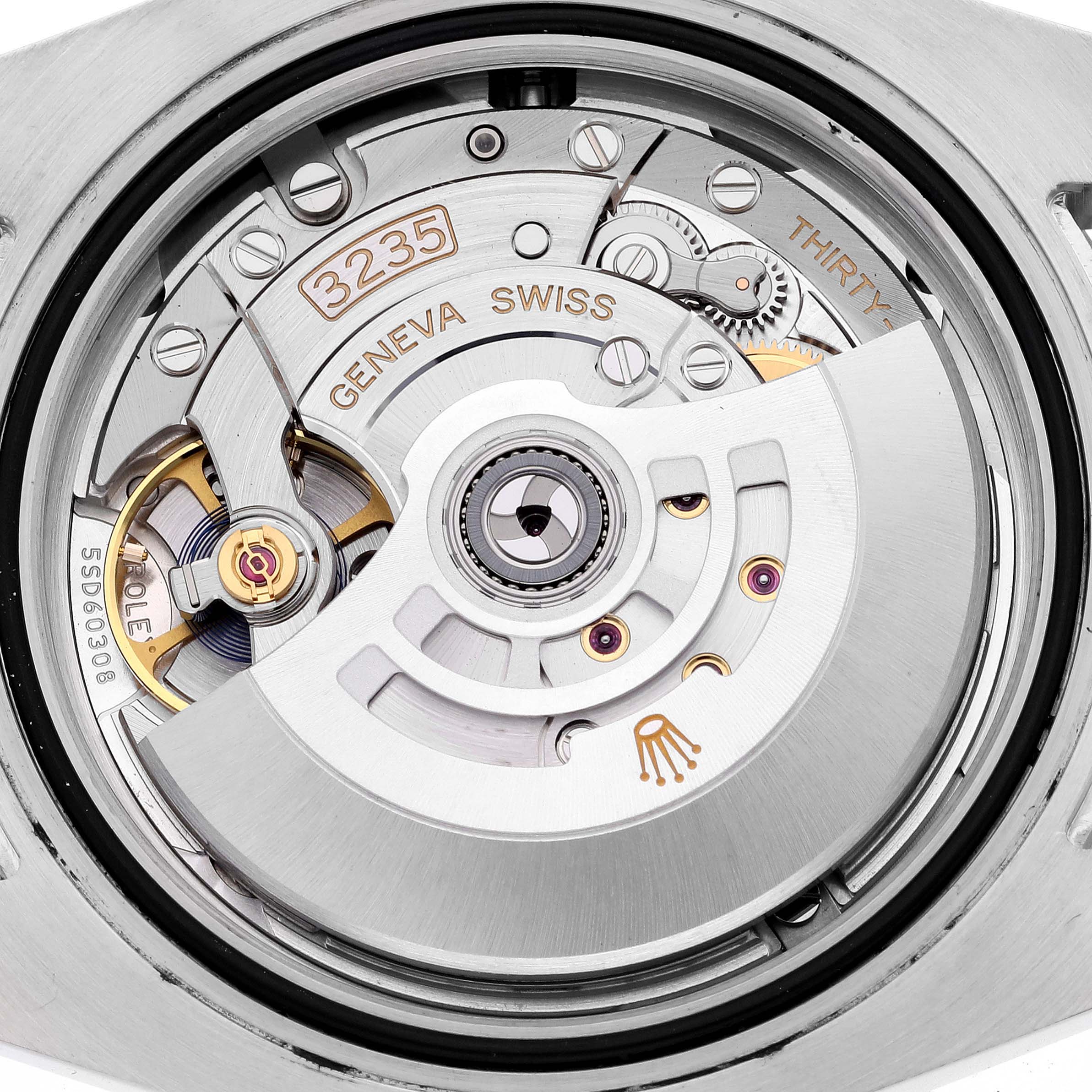 The image shows the movement of a Rolex Submariner 126613LB Men's Steel and Gold (two tone) Blue Dial 126613LB Men's Steel and Gold (two tone) Blue Dial, focusing on the intricate internal mechanism and rotor.