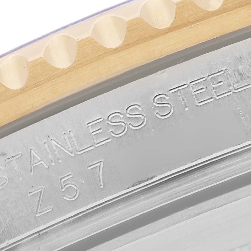 The image shows a close-up of the bezel and case edge of a Rolex Submariner 16613 Men's Steel and Gold (two tone) Blue Dial 16613 Men's Steel and Gold (two tone) Blue Dial, highlighting the engraving.