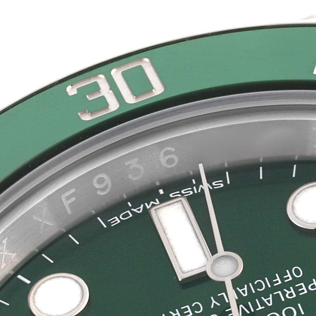 The image shows part of the bezel and dial of a Rolex Submariner 116610LV Men
s Stainless Steel Green Dial 116610LV Men
s Stainless Steel Green Dial from an angled close-up view.