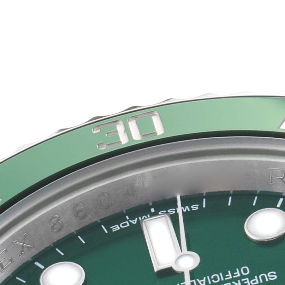 This close-up image shows the bezel and part of the dial of a Rolex Submariner 116610LV Men's Stainless Steel Green Dial watch, focusing on the 30-minute mark.