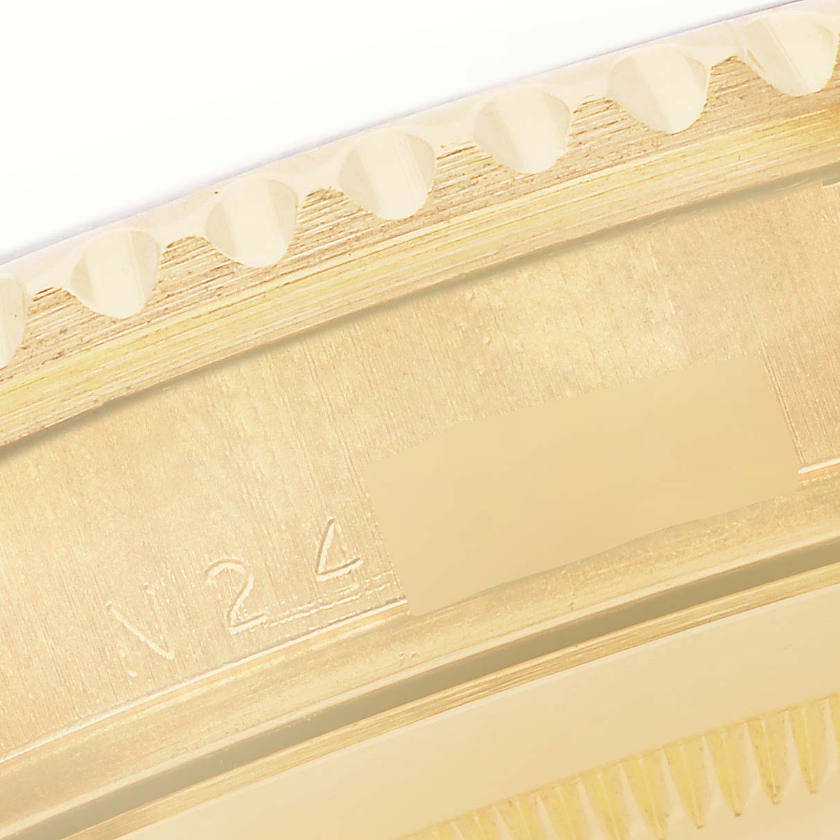 The image shows a close-up of the outer edge and part of the bezel teeth of a Rolex Submariner 16618 Men
s Yellow Gold Black Dial 16618 Men
s Yellow Gold Black Dial watch.