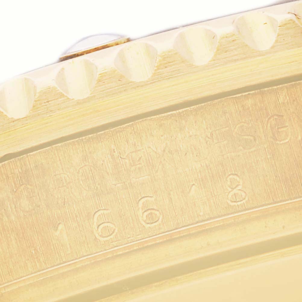 The image shows the side engraving and part of the bezel of a Rolex Submariner 16618 Men
s Yellow Gold Black Dial 16618 Men
s Yellow Gold Black Dial.