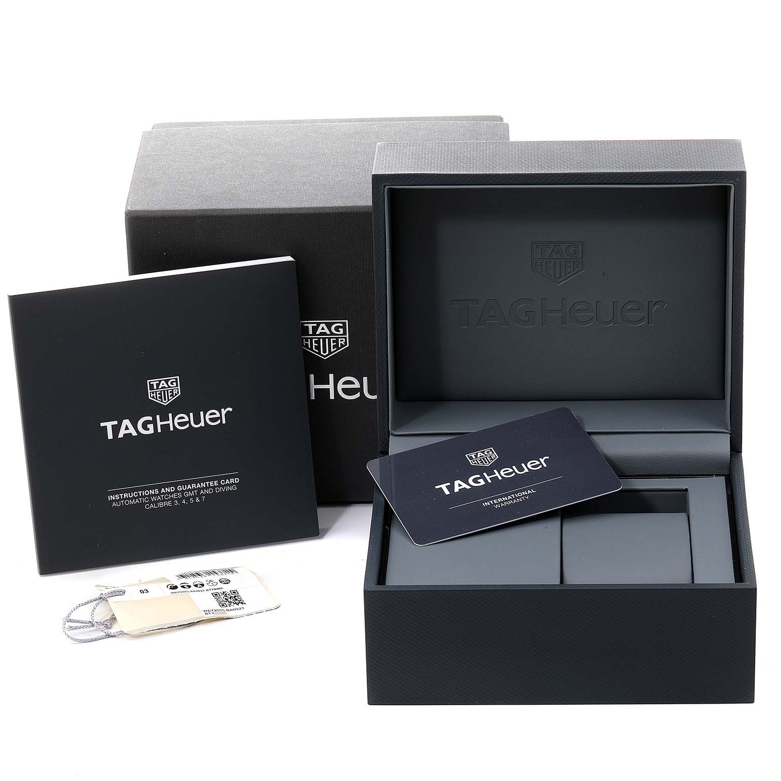 The image shows a Tag Heuer Aquaracer WAY2015.BA0927 Men's Stainless Steel Green Dial WAY2015.BA0927 Men's Stainless Steel Green Dial watch box, instruction manual, guarantee card, and a tag, viewed from the front.