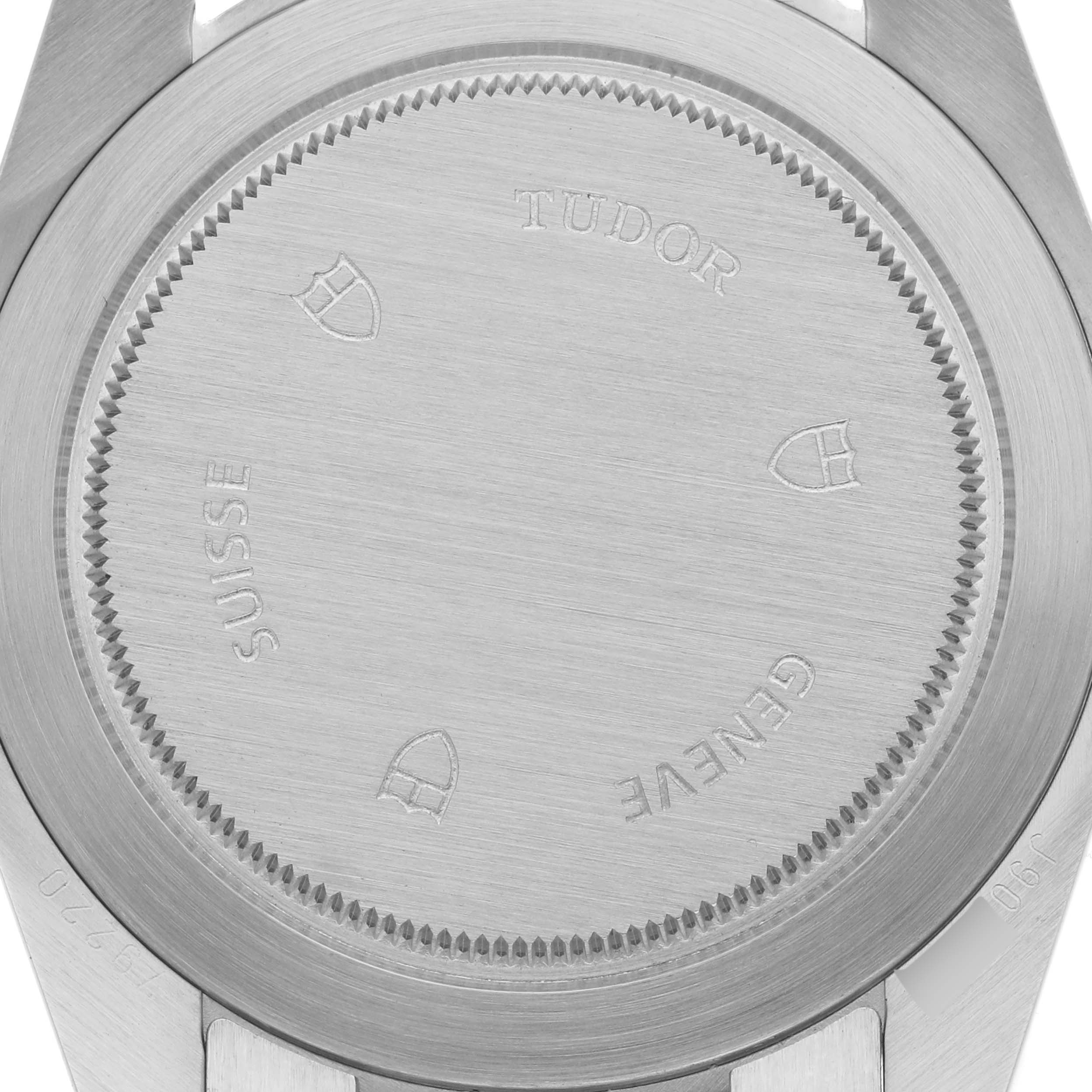 The image shows the back case of the Tudor Heritage Black Bay 79220R Men
s Stainless Steel Black Dial 79220R Men
s Stainless Steel Black Dial watch, highlighting the brushed metal surface and engravings.