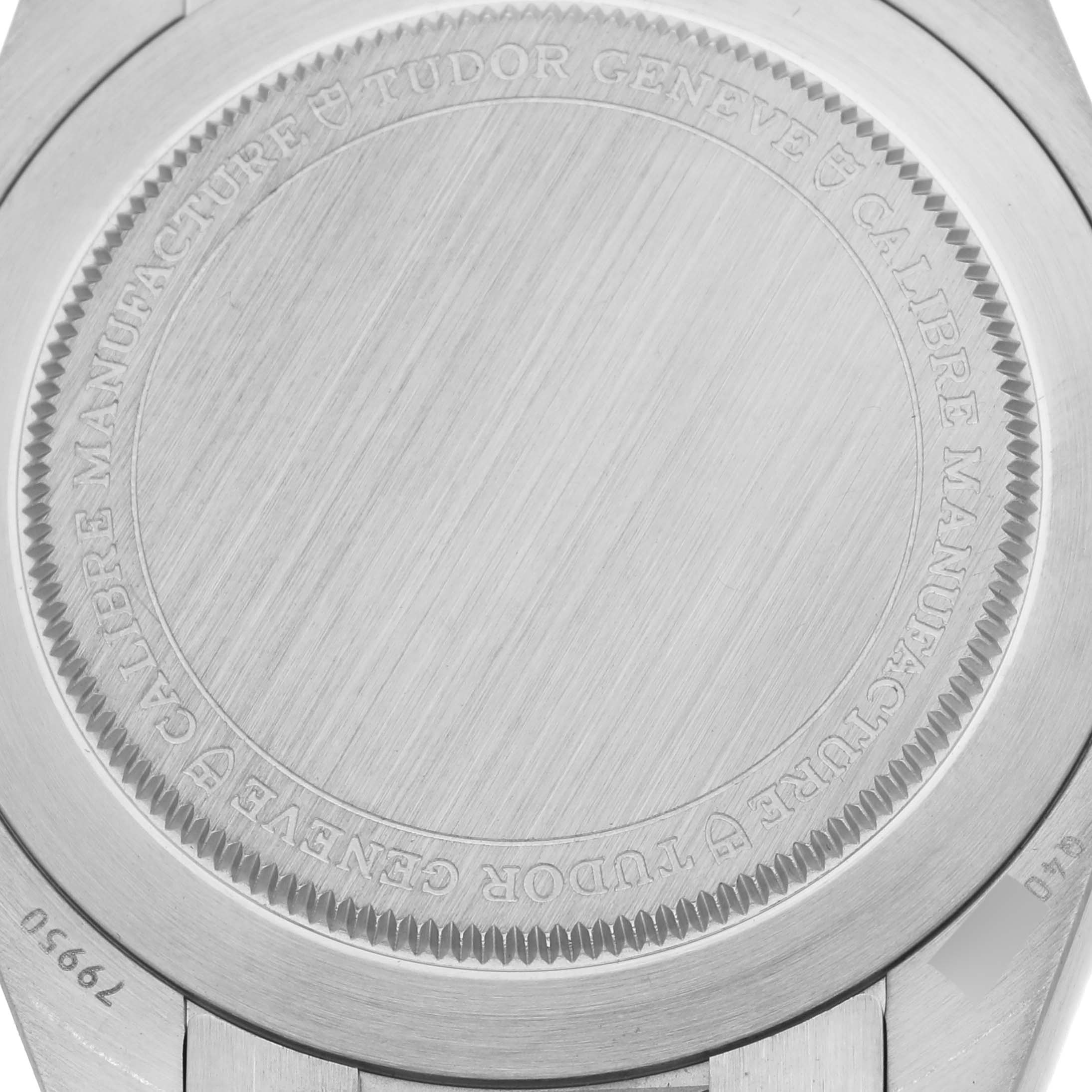 The image shows the back case of the Tudor Monarch 79950-0001 Men's Stainless Steel Black Dial 79950-0001 Men's Stainless Steel Black Dial watch, featuring engraved details and model number.