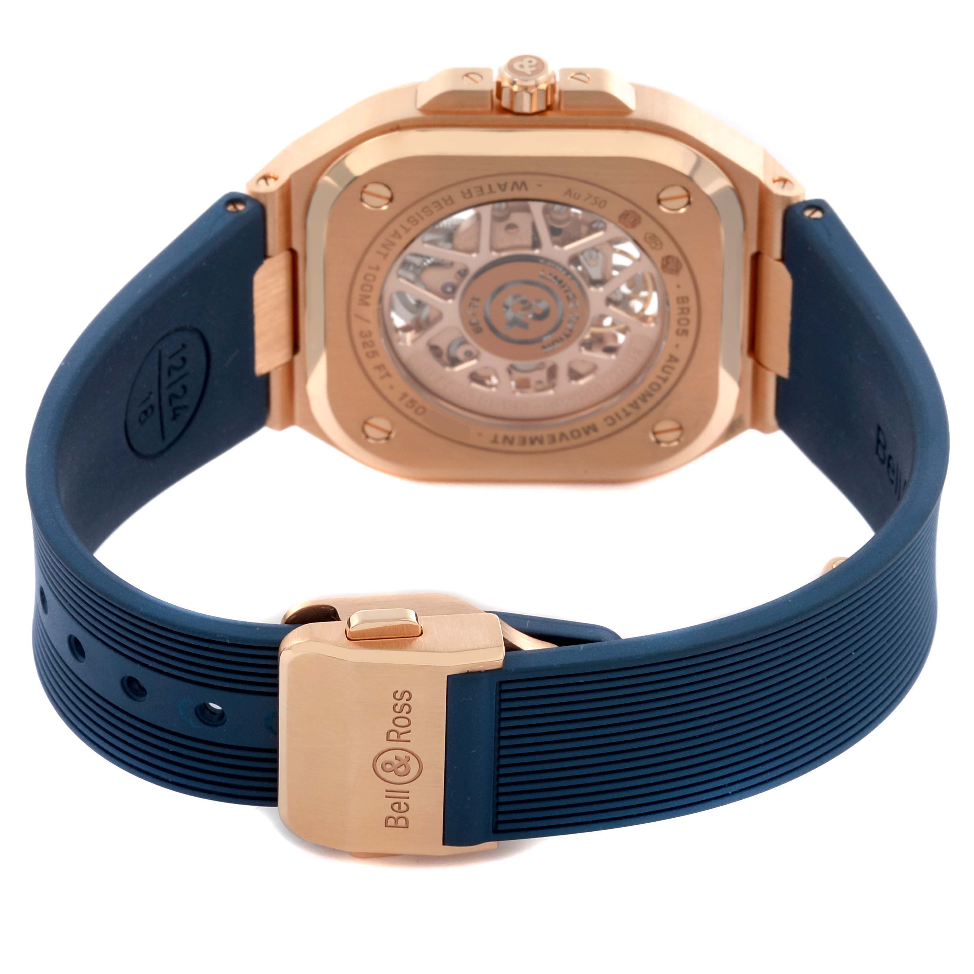 The Bell 
Ross Urban BR05A-PG-SK-PG/SRB Men
s Rose Gold Transparent Dial BR05A-PG-SK-PG/SRB Men
s Rose Gold Transparent Dial model is shown from the back, displaying its case back and blue strap with a clasp.