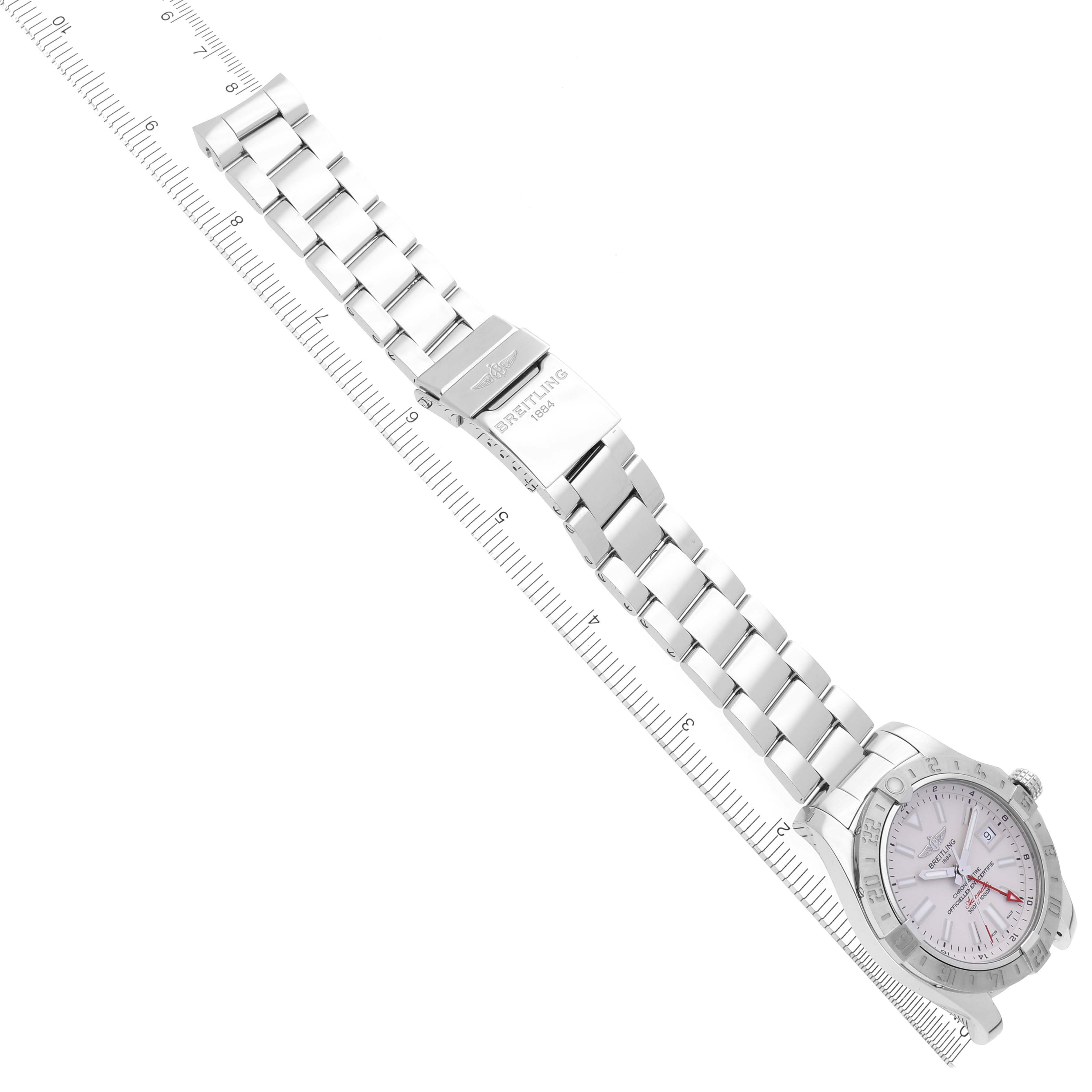 The Breitling Avenger A32390 Men's Stainless Steel White Dial A32390 Men's Stainless Steel White Dial watch is shown at an angle displaying the full bracelet, clasp, and dial alongside a ruler.