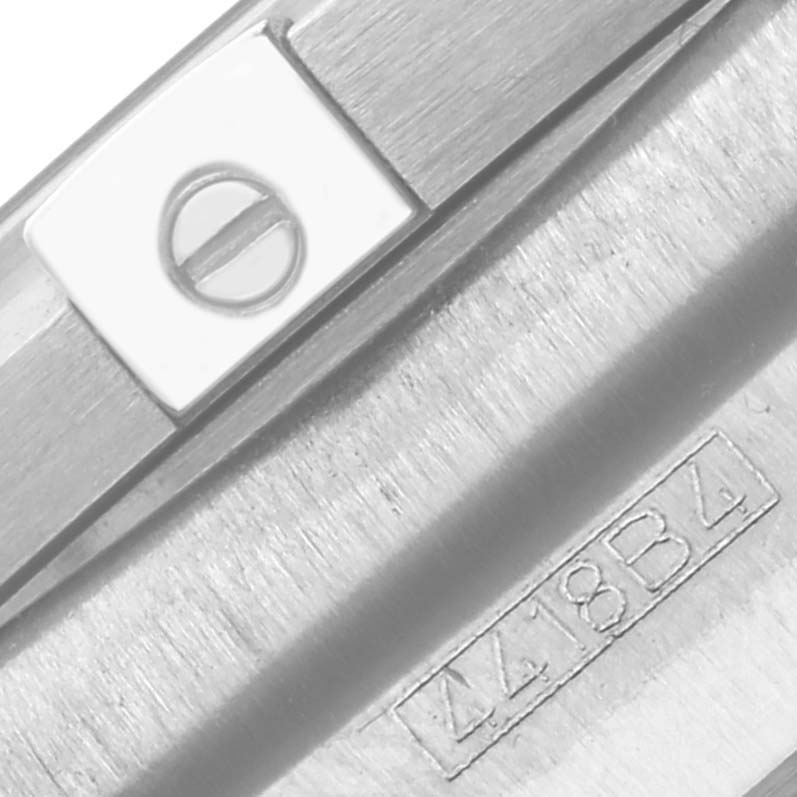 The image shows a side view of the Breitling Chronomat AB0115 Men's Stainless Steel Blue Dial AB0115 Men's Stainless Steel Blue Dial casing, highlighting a screw head and engraved serial number.