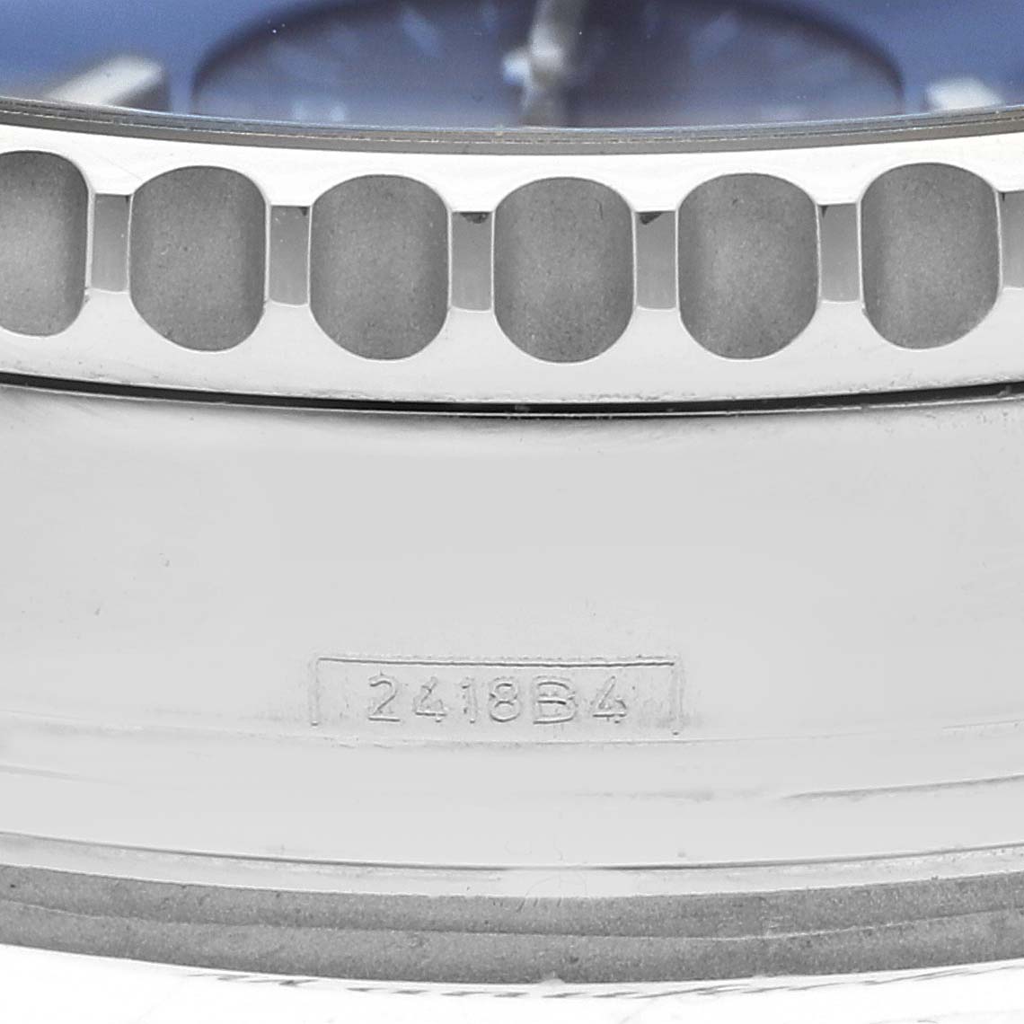 This close-up angle shows the bezel and part of the casing of a Breitling Navitimer AB0121 Men
s Stainless Steel Blue Dial AB0121 Men
s Stainless Steel Blue Dial watch, along with the model number "2418B4."