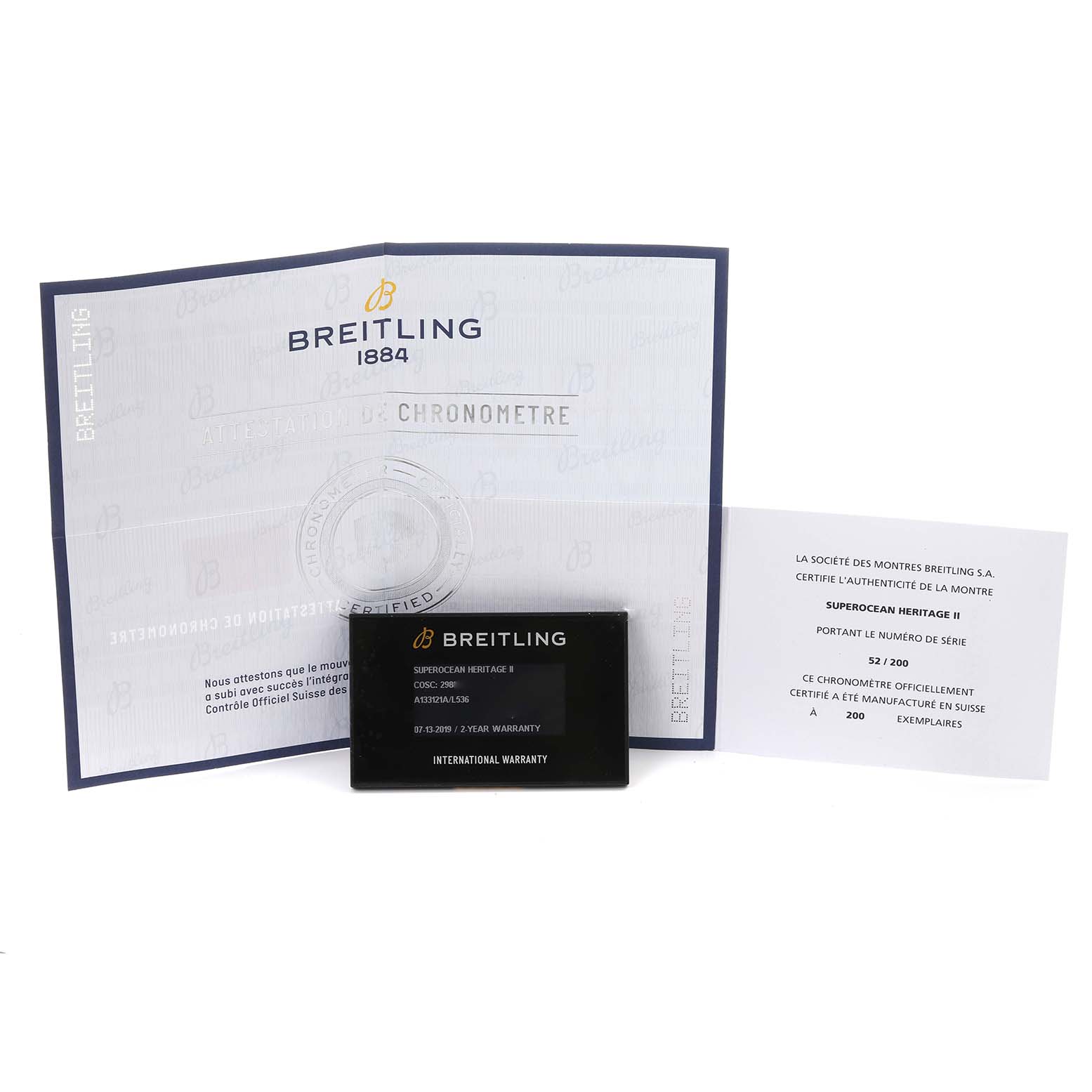 The image shows documents and a warranty card for the Breitling Superocean A13312 Men's Stainless Steel Green Dial A13312 Men's Stainless Steel Green Dial model.