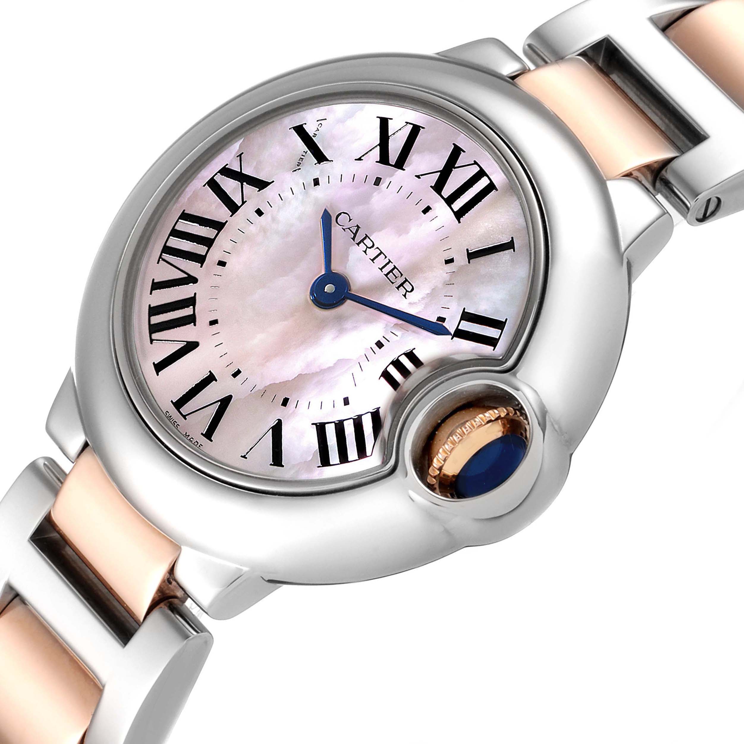 The image shows a close-up angle of the dial and part of the bracelet of a Ballon Bleu model by Cartier.