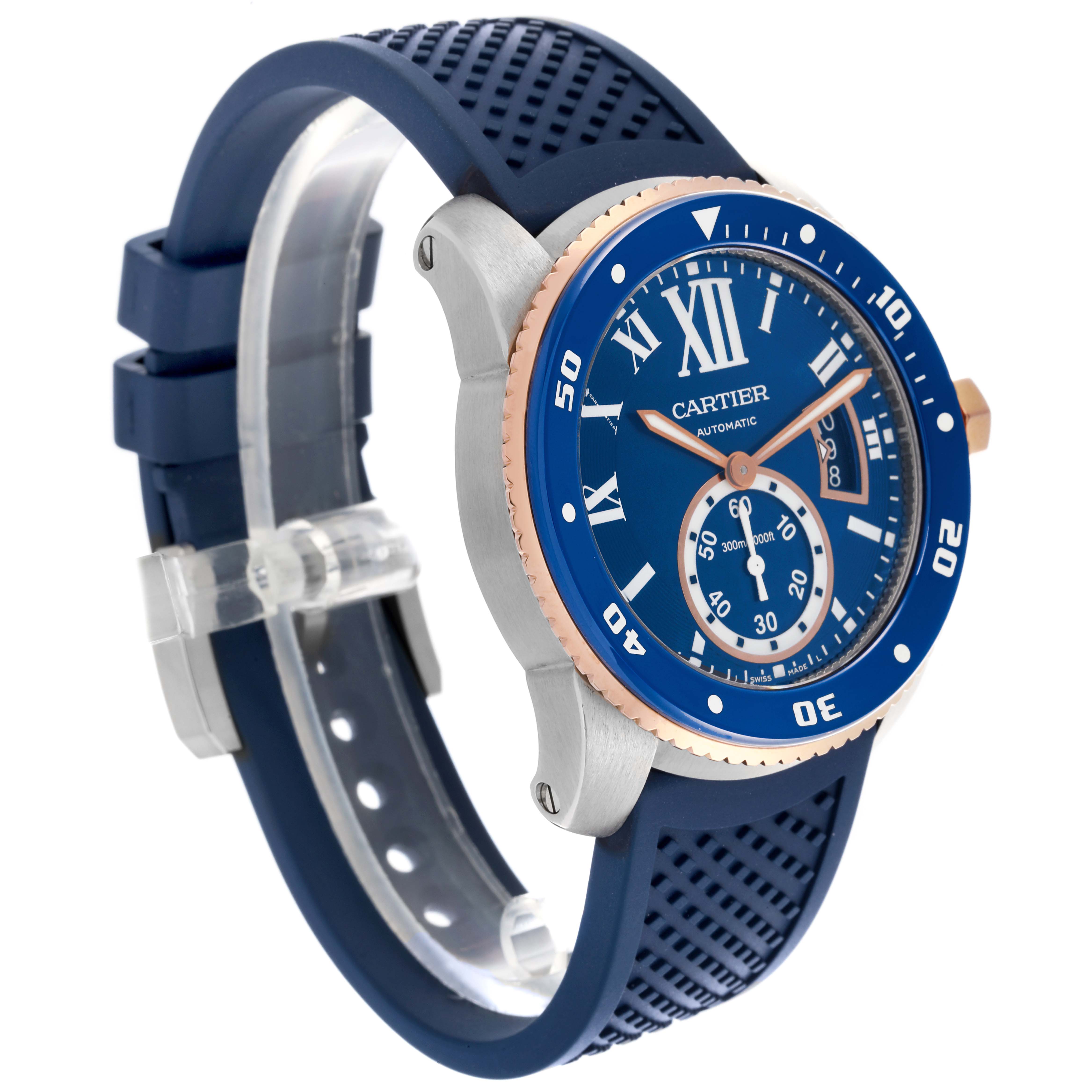 The Calibre de Cartier watch is shown at a three-quarter angle, highlighting the blue dial, bezel, and rubber strap.