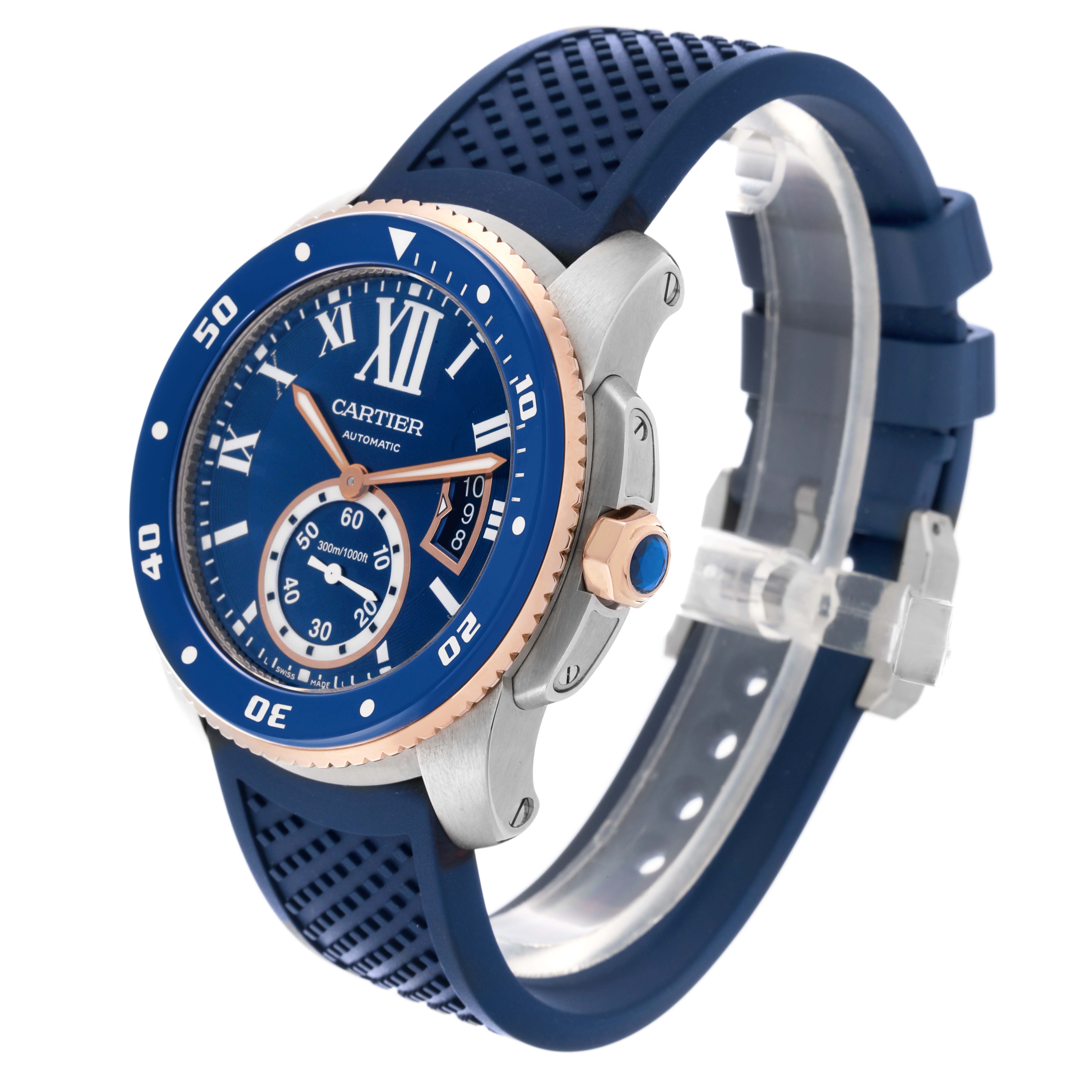 The Calibre de Cartier watch is shown at an angled side view, featuring the bezel, crown, and blue strap.