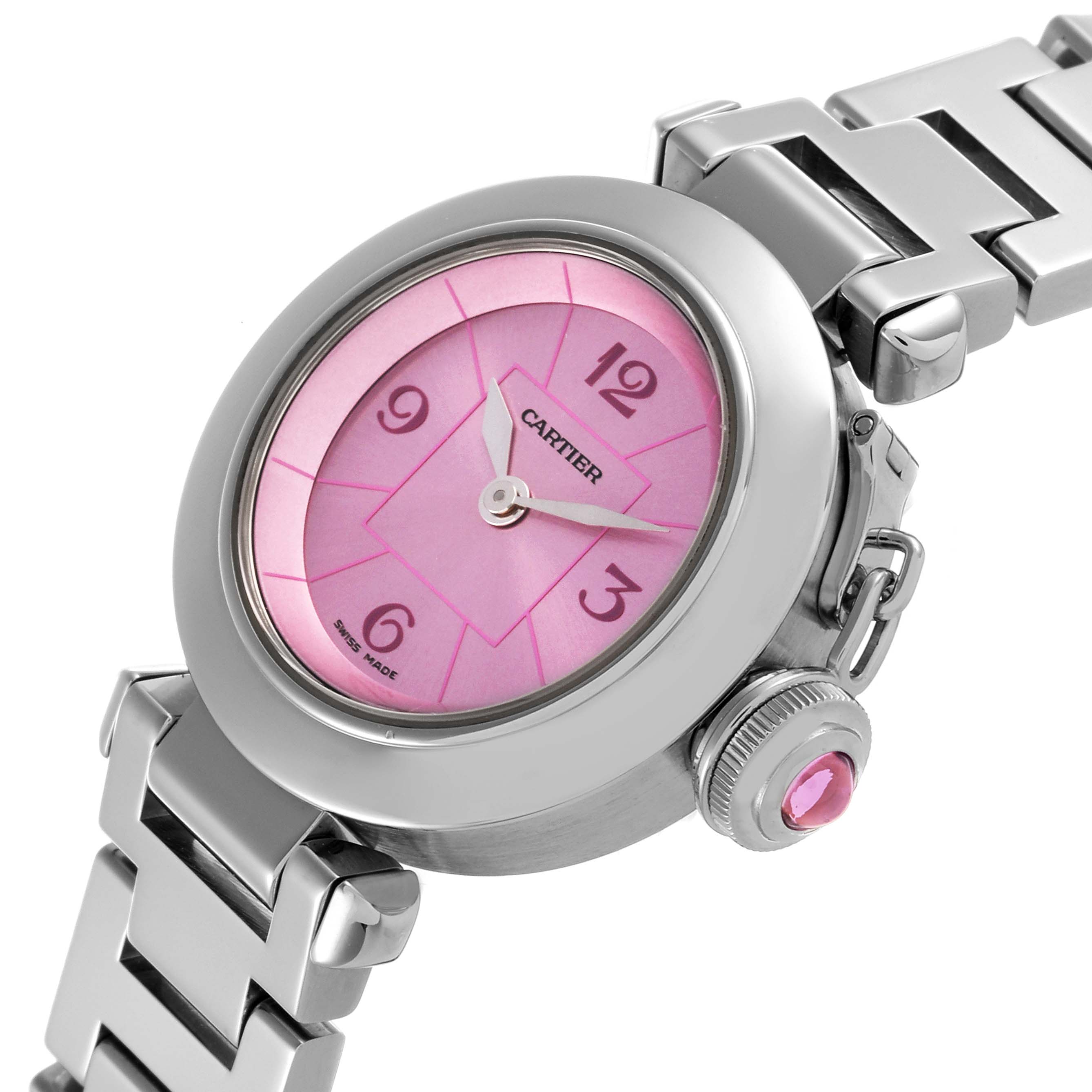 The Cartier Pasha W3140023 Women
s Stainless Steel Pink Dial W3140023 Women
s Stainless Steel Pink Dial watch is shown from a top-side angle, highlighting its pink dial, crown, and stainless steel bracelet.