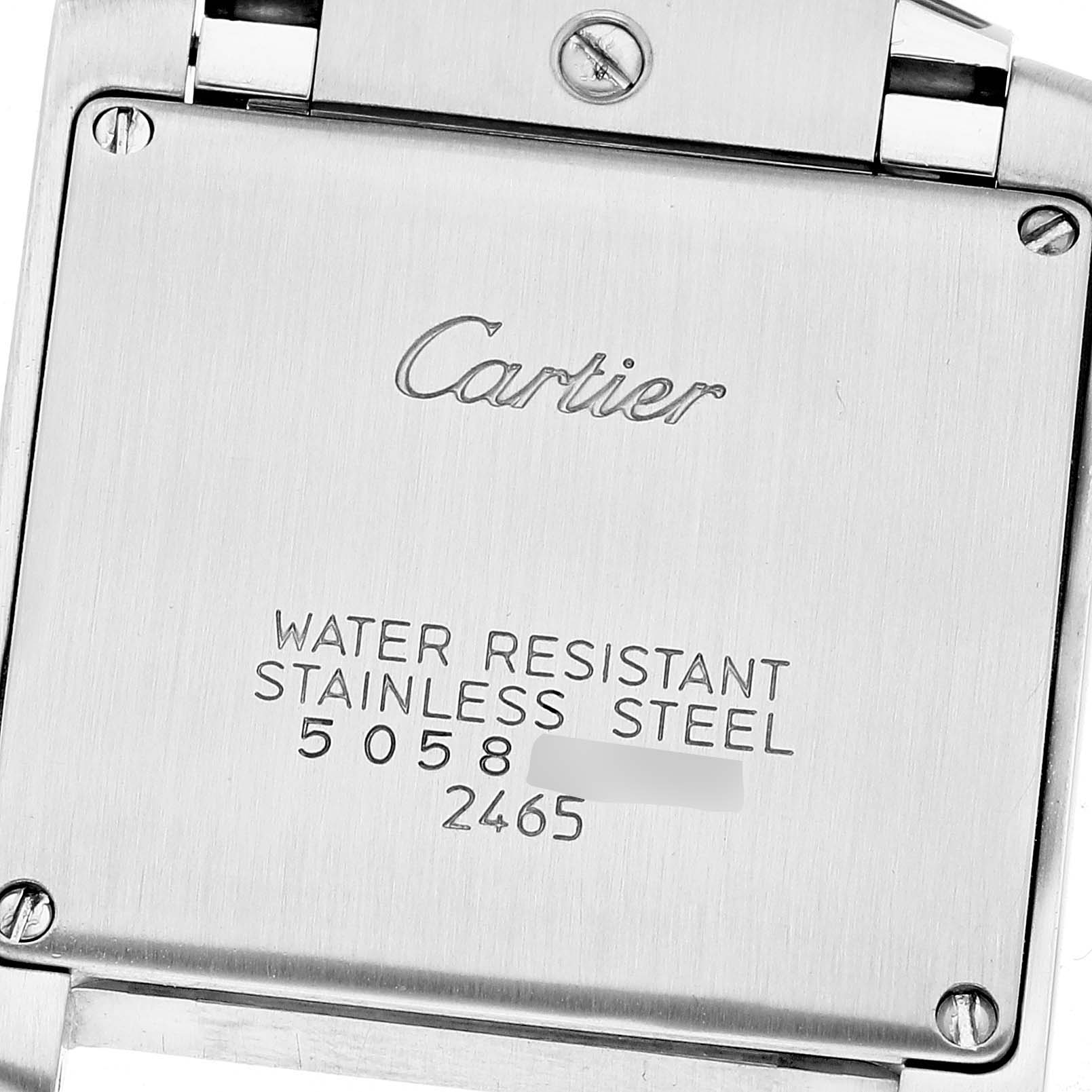 This image shows the back case of a Cartier Tank Francaise W51012Q4 Women
s Steel and Gold (two tone) Silver Dial W51012Q4 Women
s Steel and Gold (two tone) Silver Dial watch, displaying its engravings and screws.