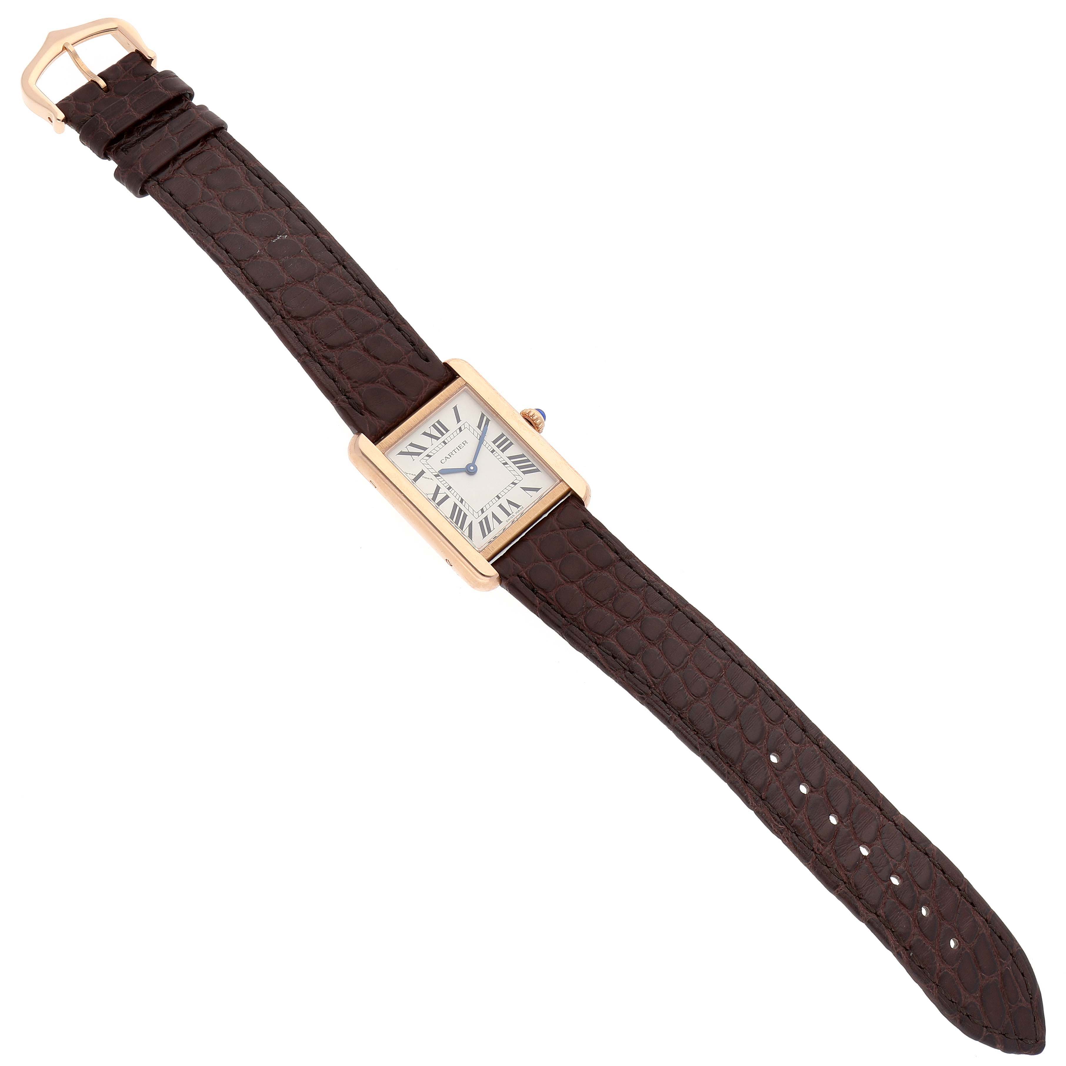 The Cartier Tank Solo W5200024 Women
s Rose Gold Silver Dial W5200024 Women
s Rose Gold Silver Dial watch is shown from a top-down angle, displaying its rectangular face and brown leather strap.