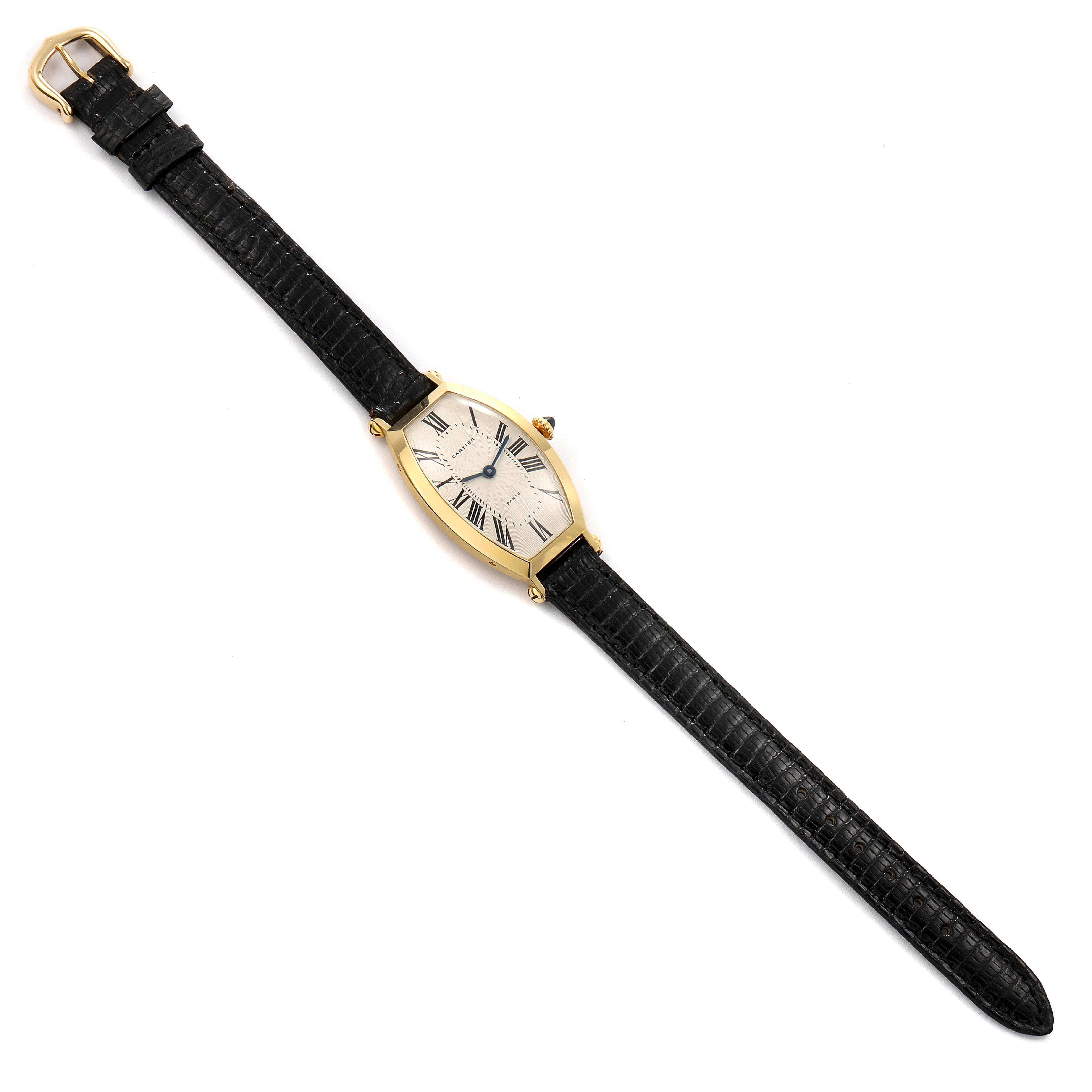 The image shows a top-down view of a Cartier Tortue Women's Yellow Gold Silver Dial Women's Yellow Gold Silver Dial watch with a black leather strap and a gold case.