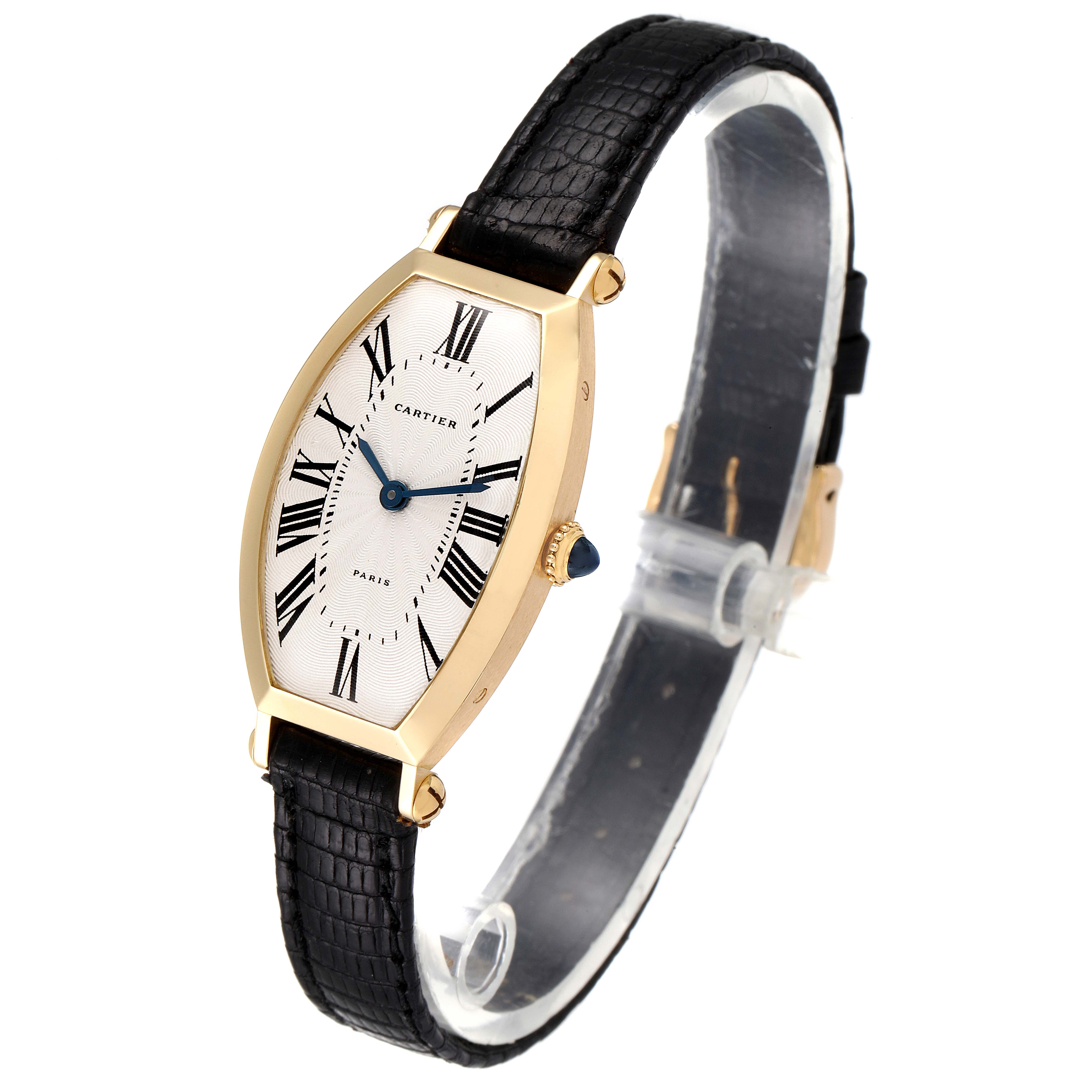The image shows a side angle of the Cartier Tortue Women's Yellow Gold Silver Dial Women's Yellow Gold Silver Dial watch, highlighting its face, case, crown, and leather strap.