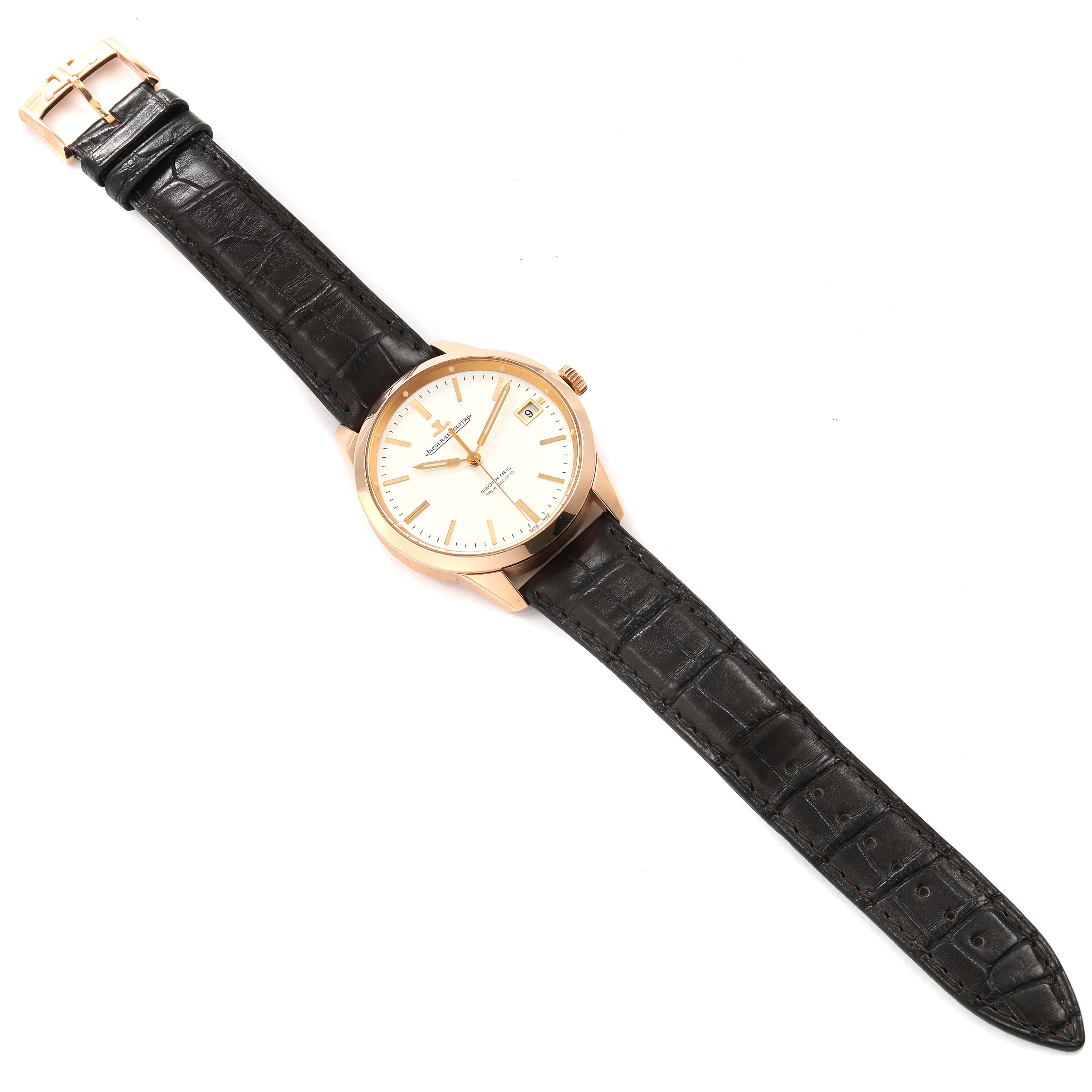 The image shows a top-down view of a Jaeger LeCoultre Geophysic Q8012520 Men's Rose Gold Silver Dial Q8012520 Men's Rose Gold Silver Dial watch with a leather strap and a light-colored dial.