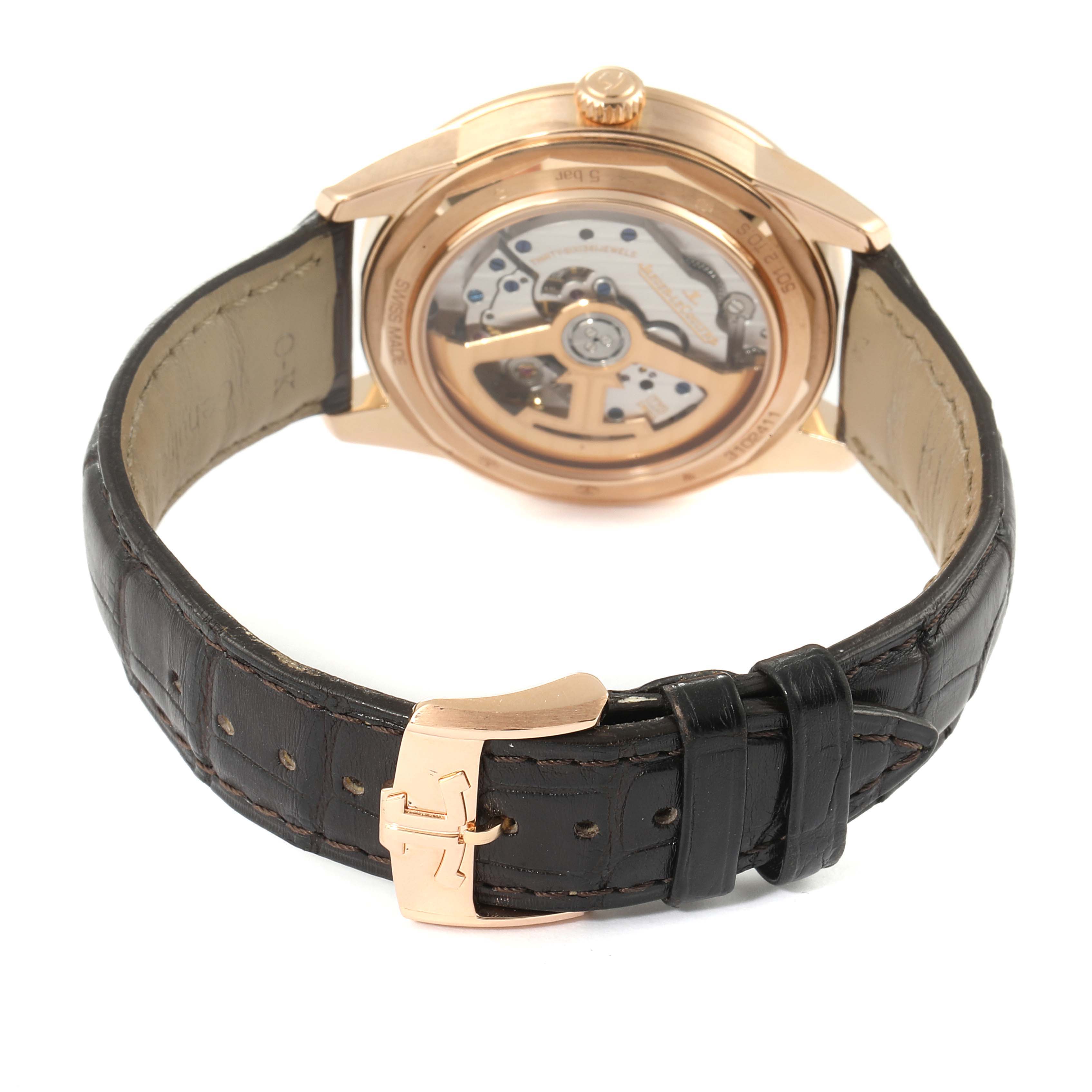 The image shows the back view of a Jaeger LeCoultre Geophysic Q8012520 Men's Rose Gold Silver Dial Q8012520 Men's Rose Gold Silver Dial watch, displaying its mechanical movement and leather strap.