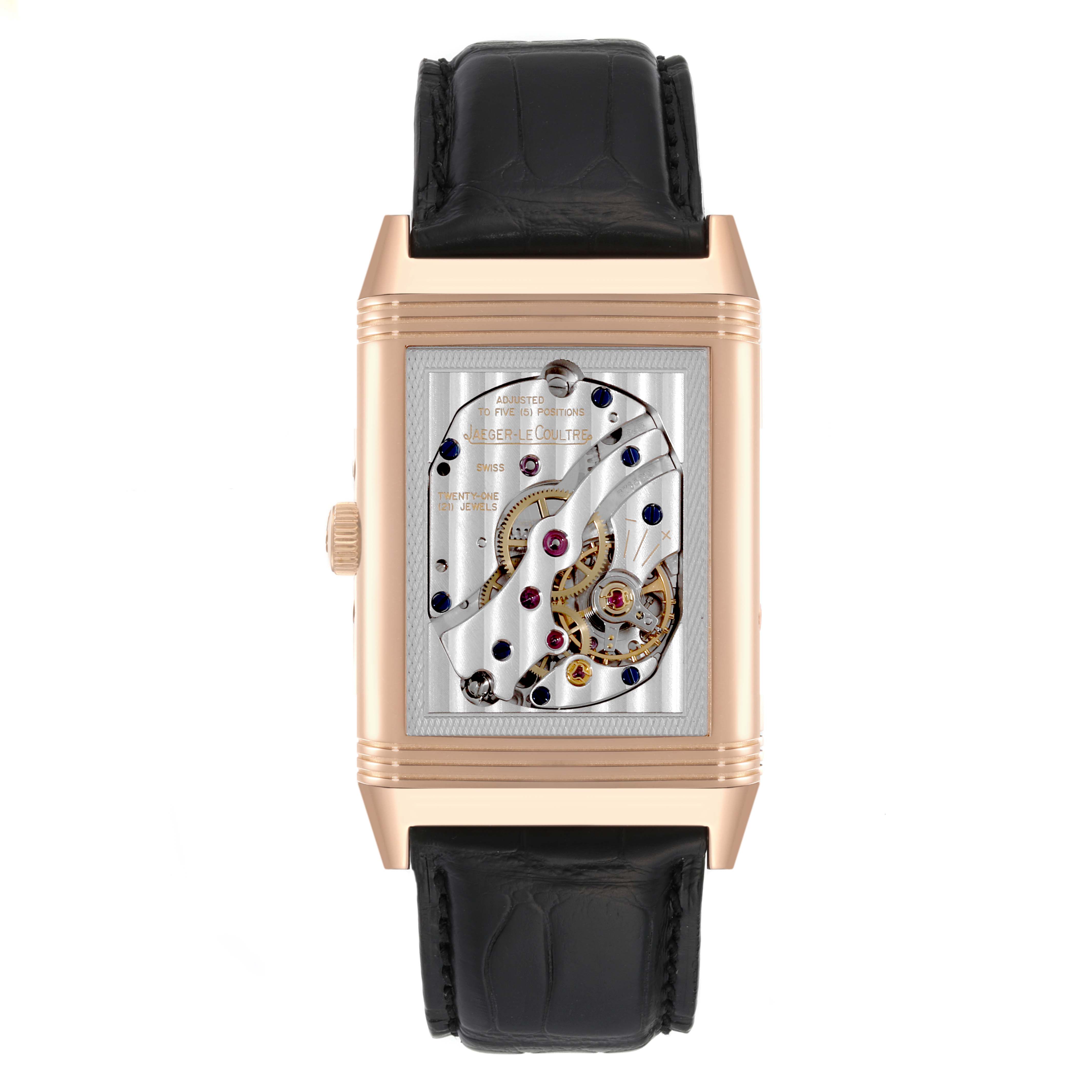 The image shows the back of a Jaeger-LeCoultre Reverso watch, highlighting its exposed mechanical movement.