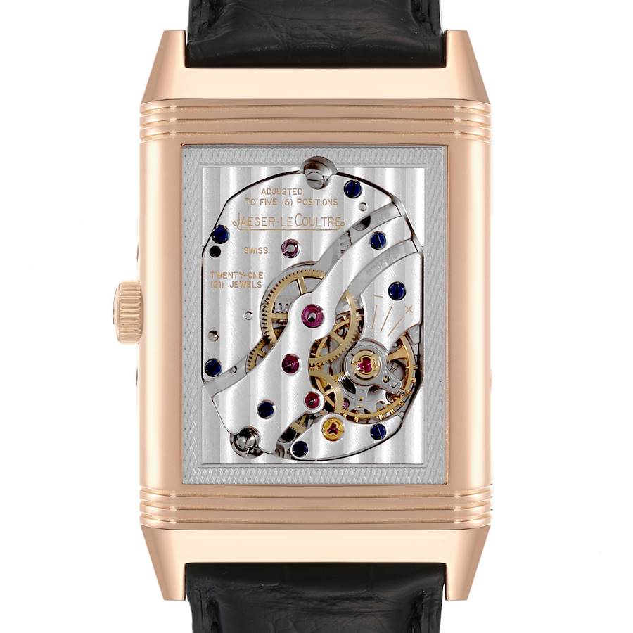 The image shows the case back of the Jaeger LeCoultre Reverso watch, displaying its intricate mechanical movement.